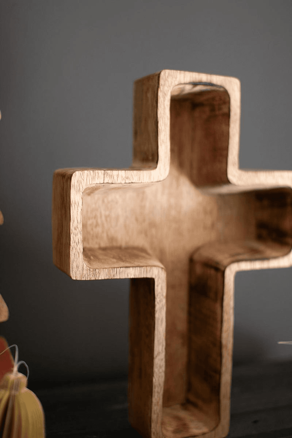 Brown wooden cross-shaped bowl with hollow center