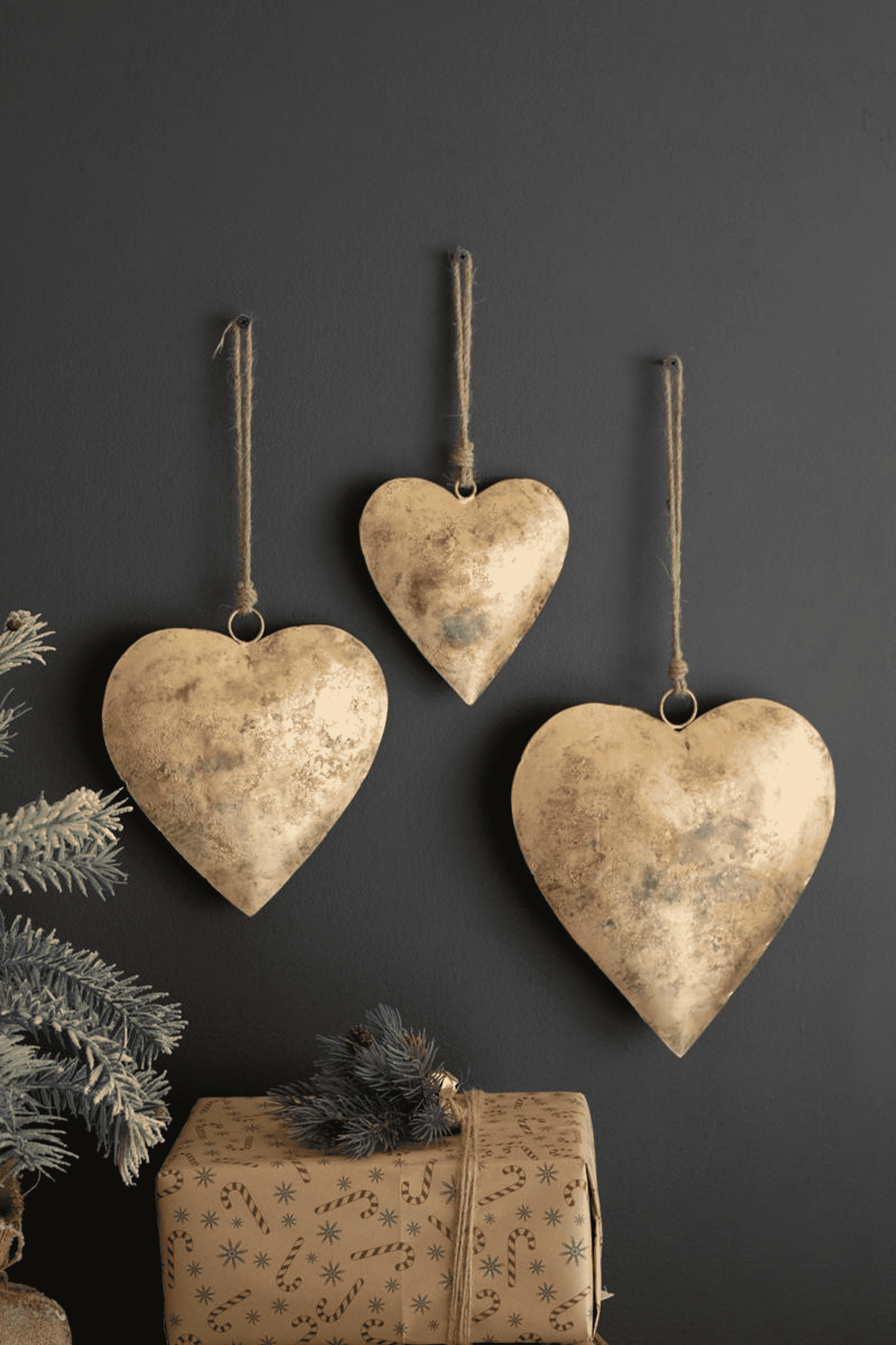 Set of three antique gold heart door hangers, each with twine hanging loop