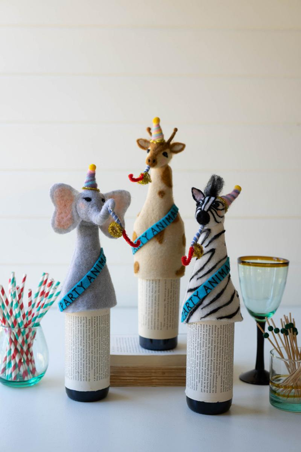 Set of three felt animal bottle toppers: elephant, giraffe, and zebra with party hats