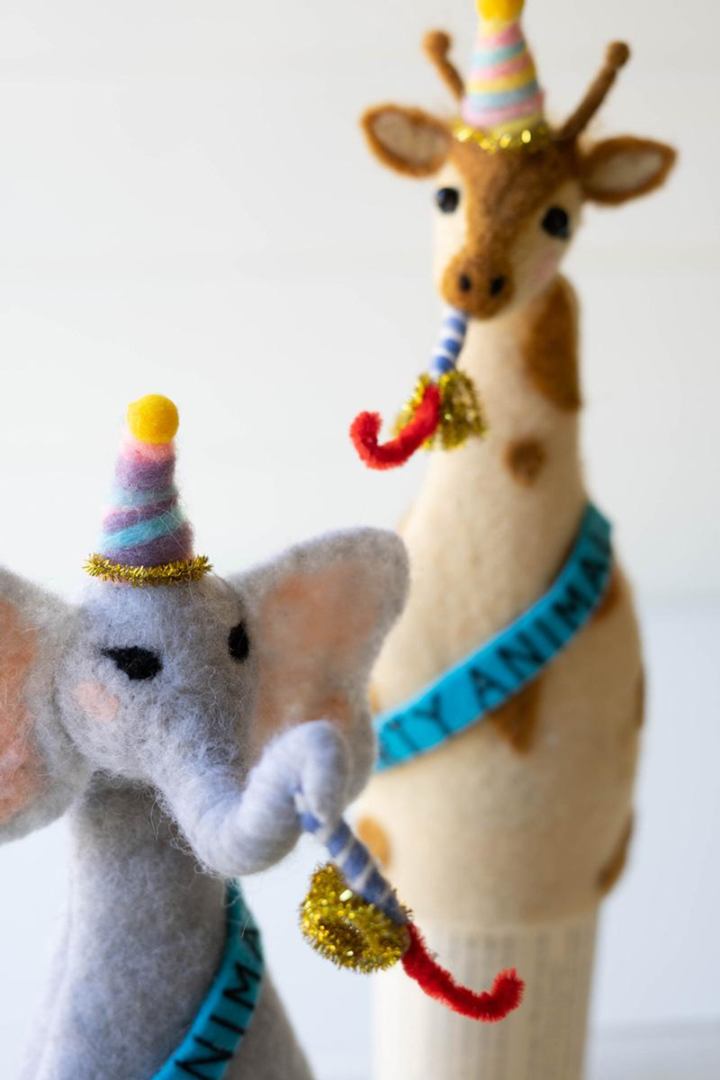 Felt elephant and giraffe bottle toppers with striped party hats and ribbon ties