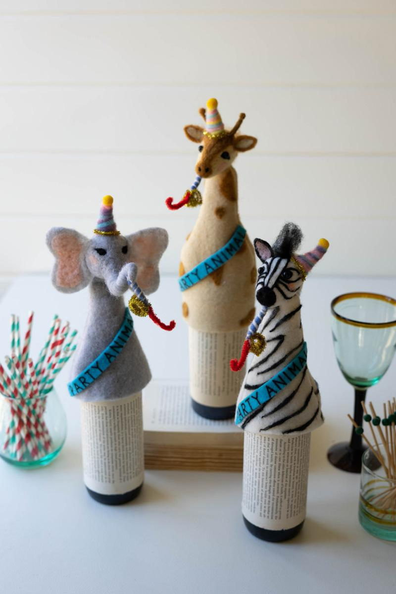 Three felt animal bottle toppers on drink bottles: elephant, giraffe, and zebra