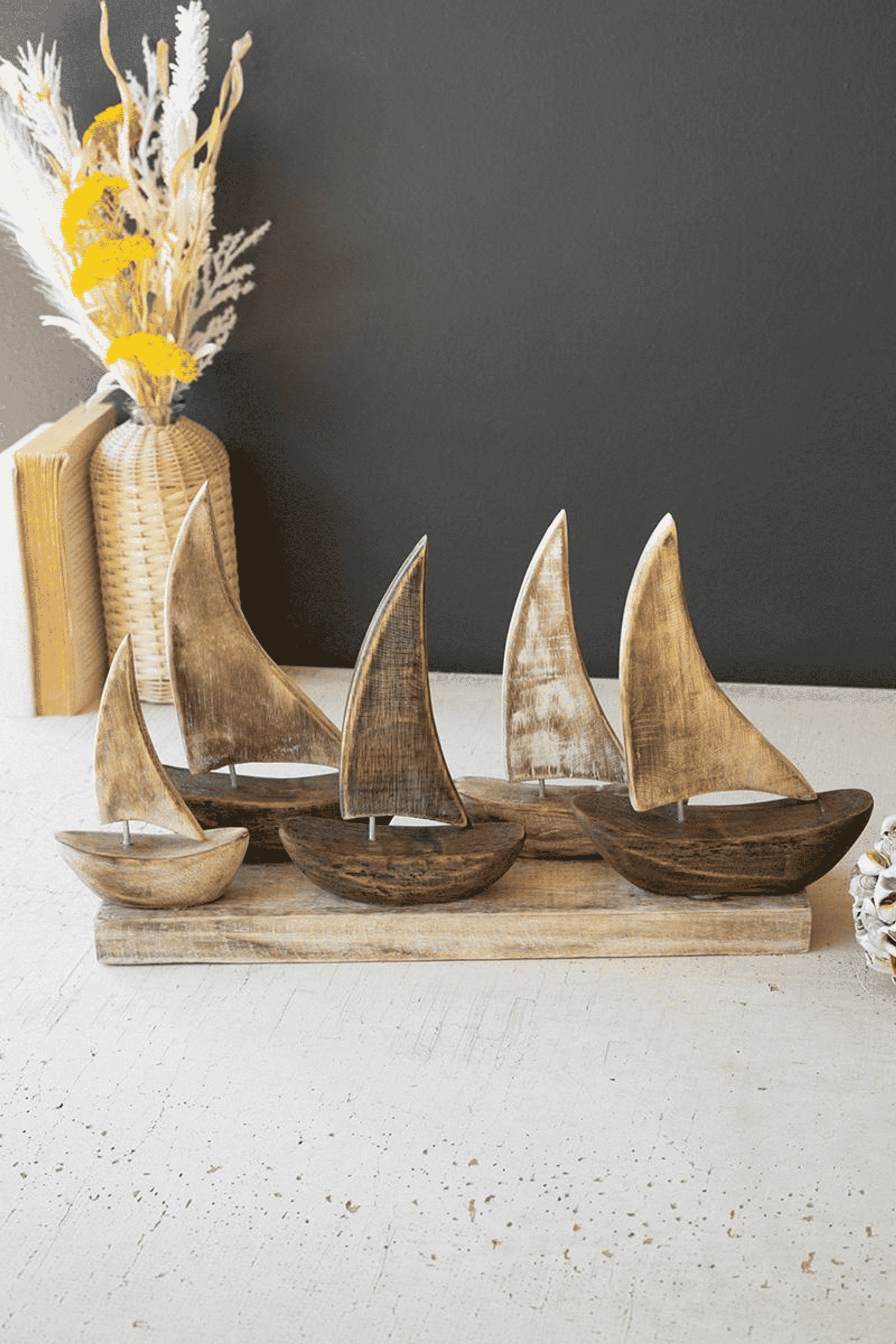 Wooden sail boats (five) with tall sails on a rectangular base