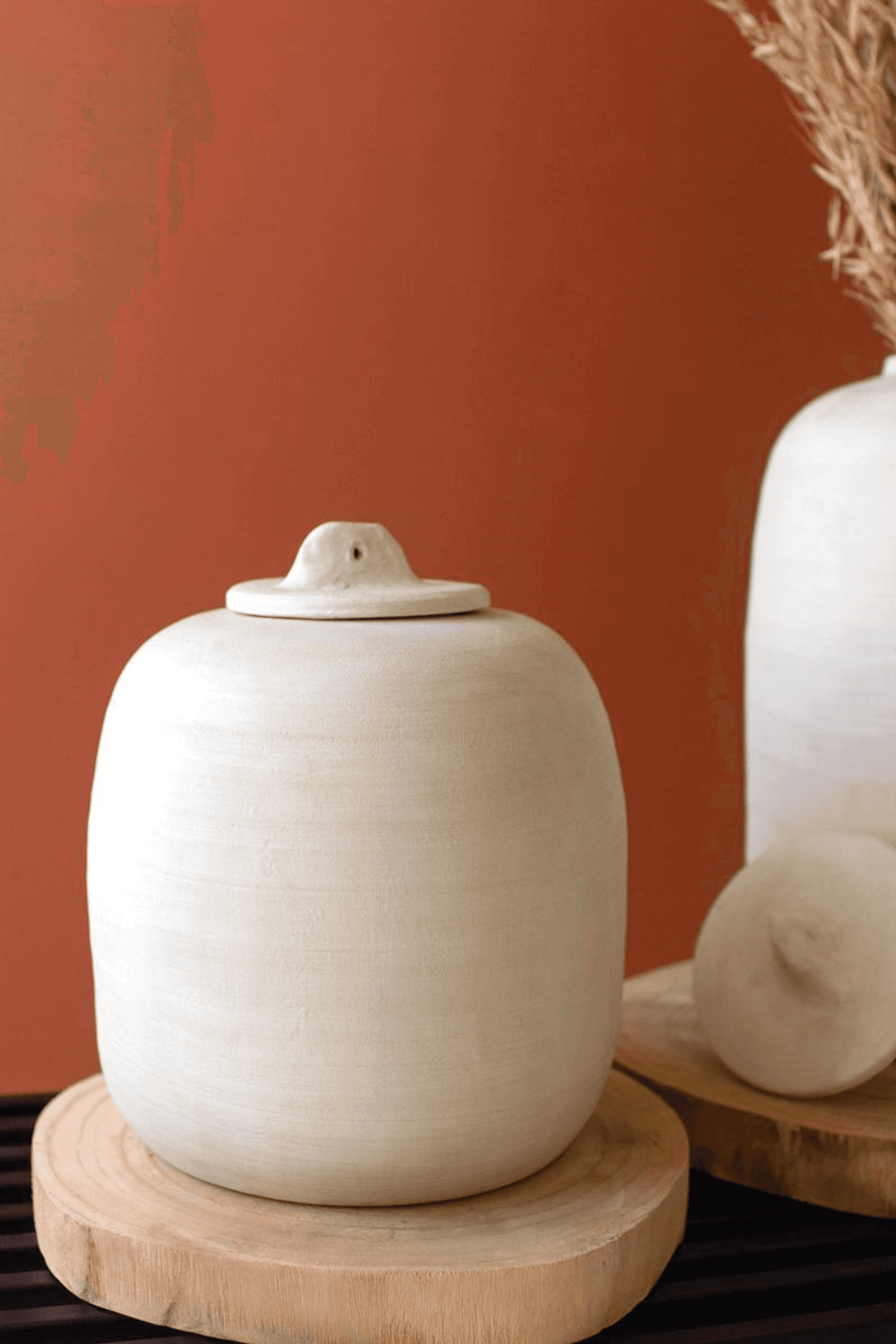 Off-white ceramic canister with domed lid on round wooden base, small size