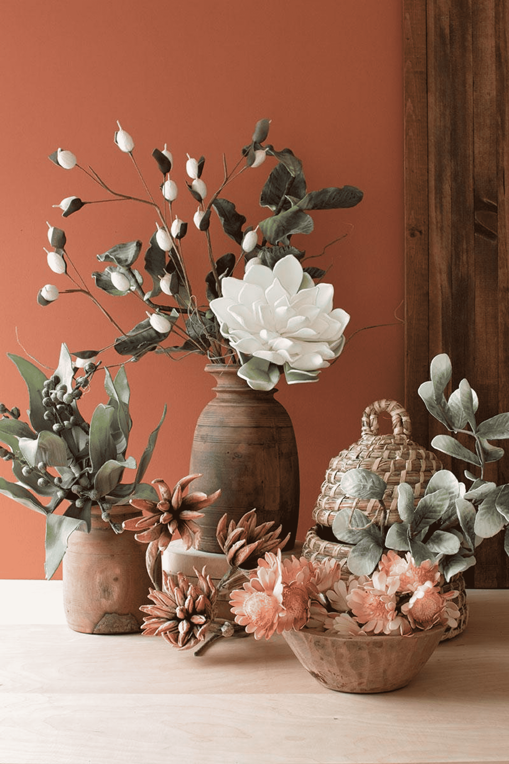 Artificial floral arrangement with eucalyptus stems and assorted blooms in pots