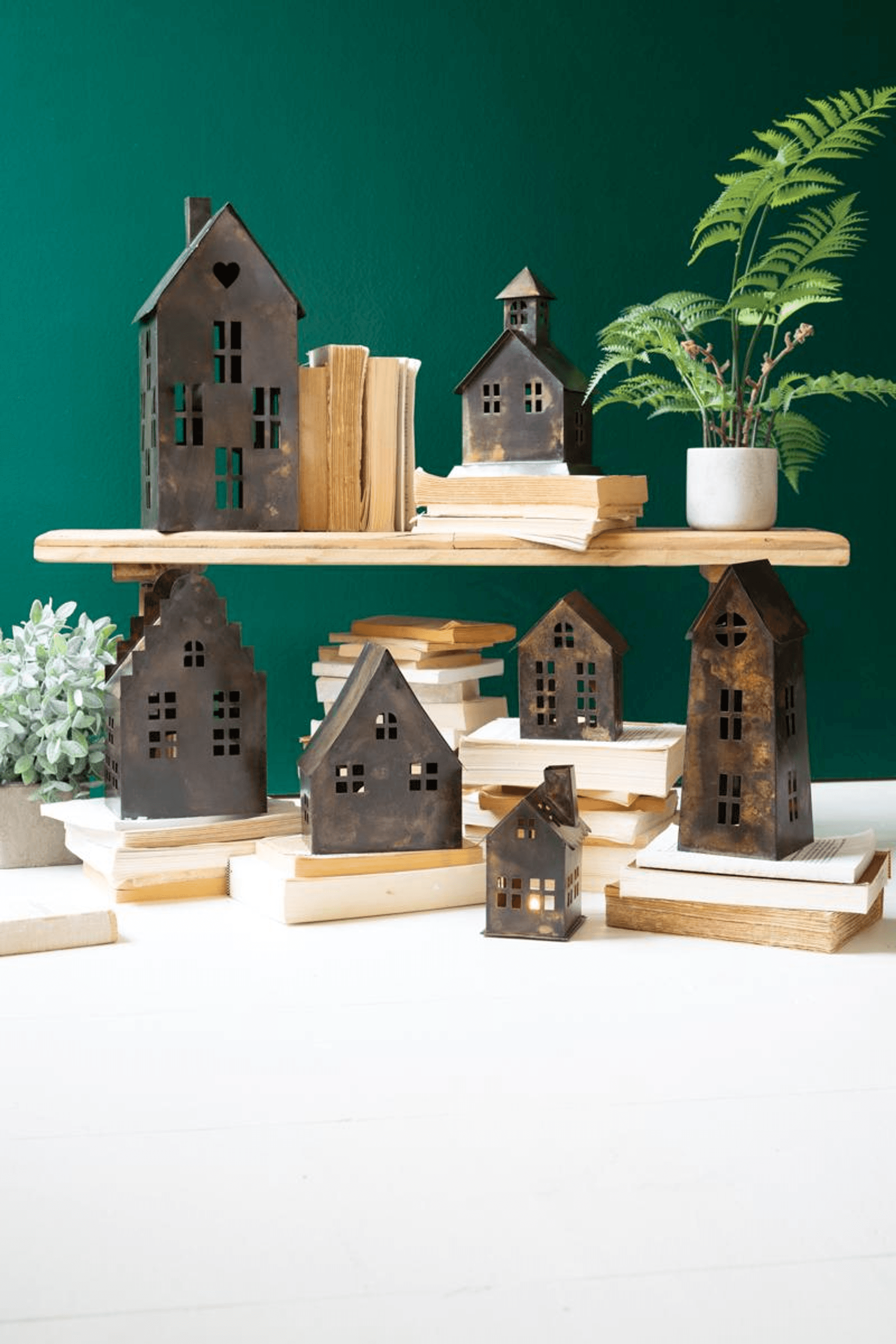 Set of seven antique brown metal village houses with window cutouts