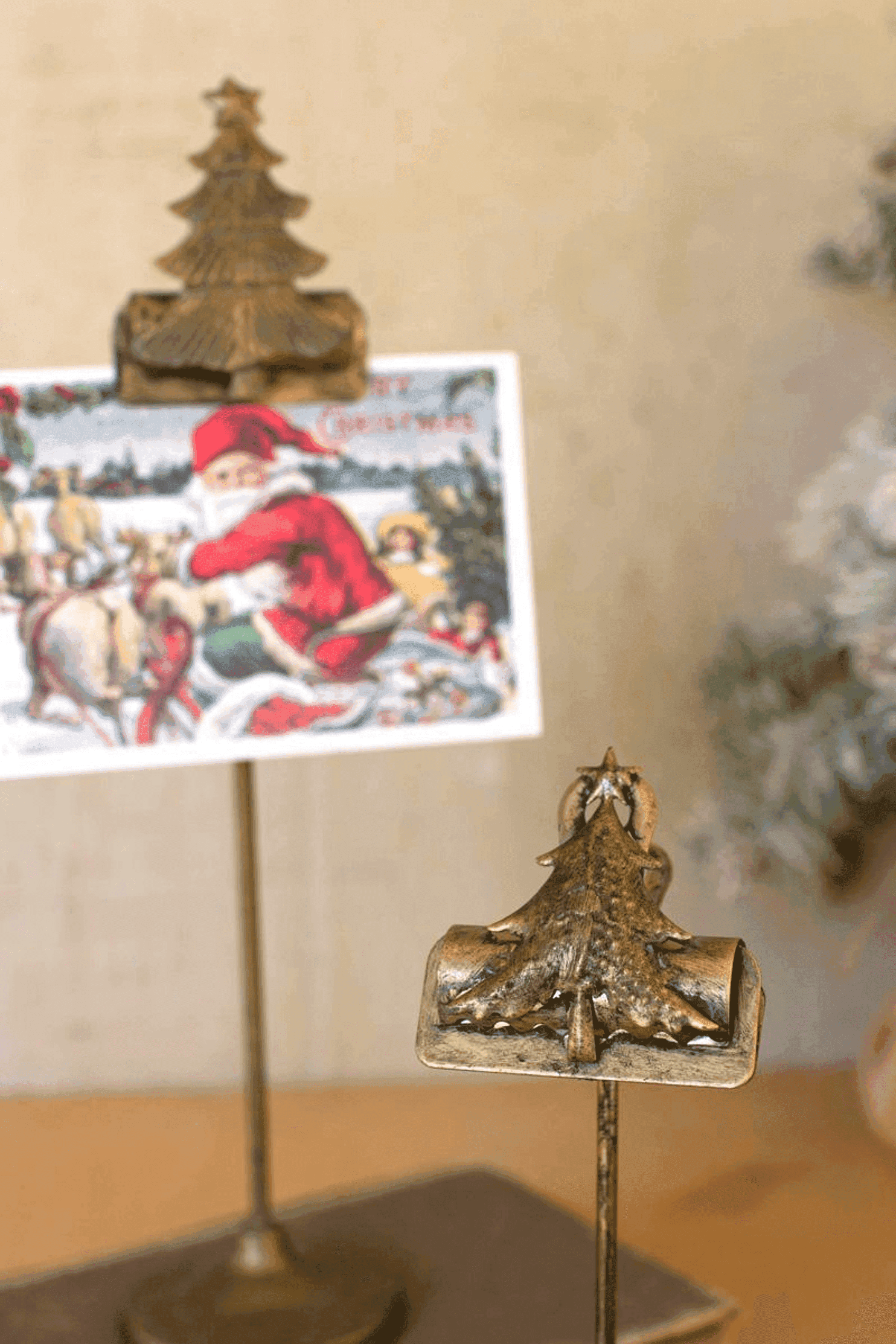 Gold Christmas tree card clip on stand holding a decorative holiday card