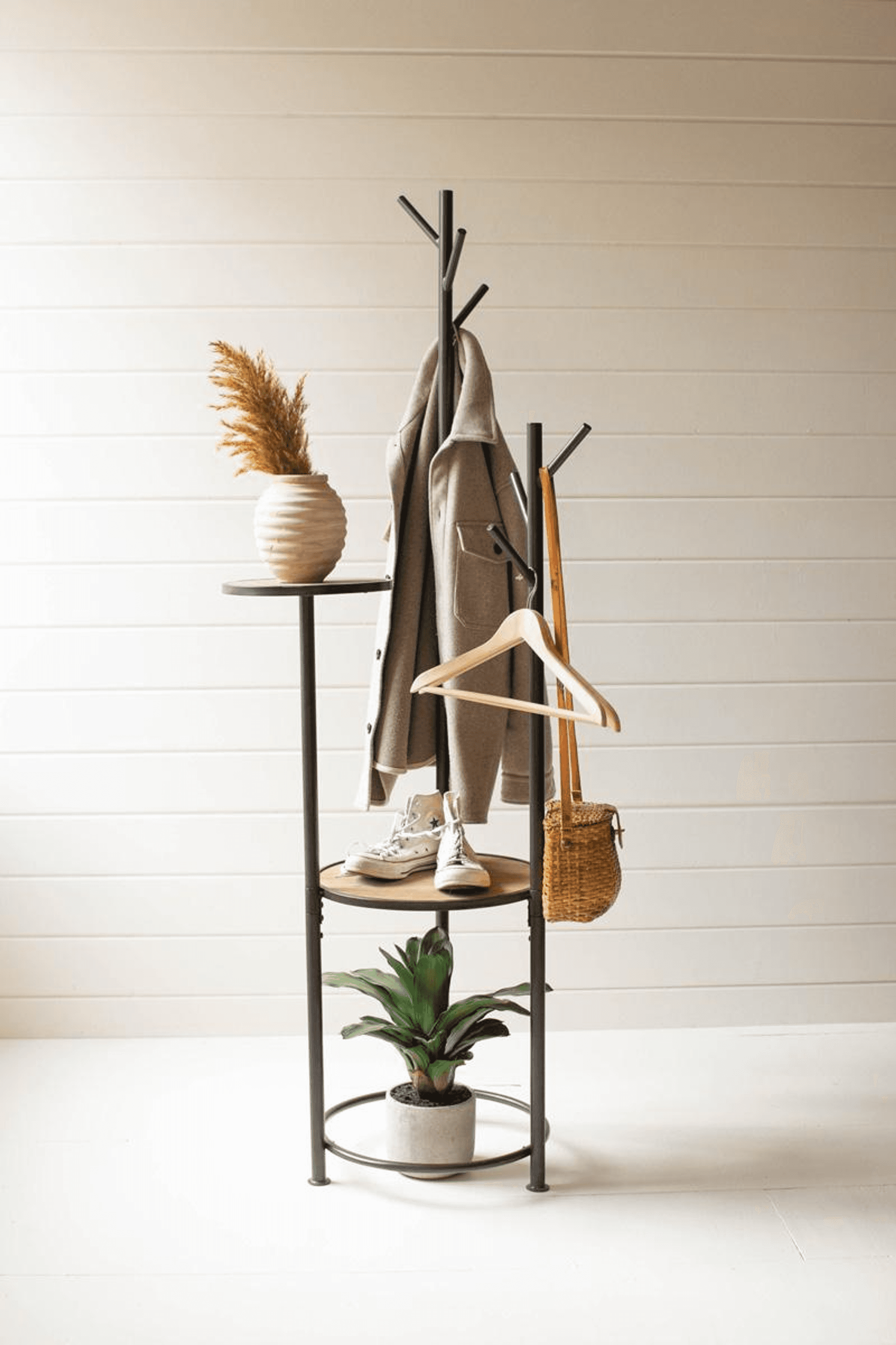 Gray metal coat rack with a round shelf base, multiple hooks, and light-wood side accents.
