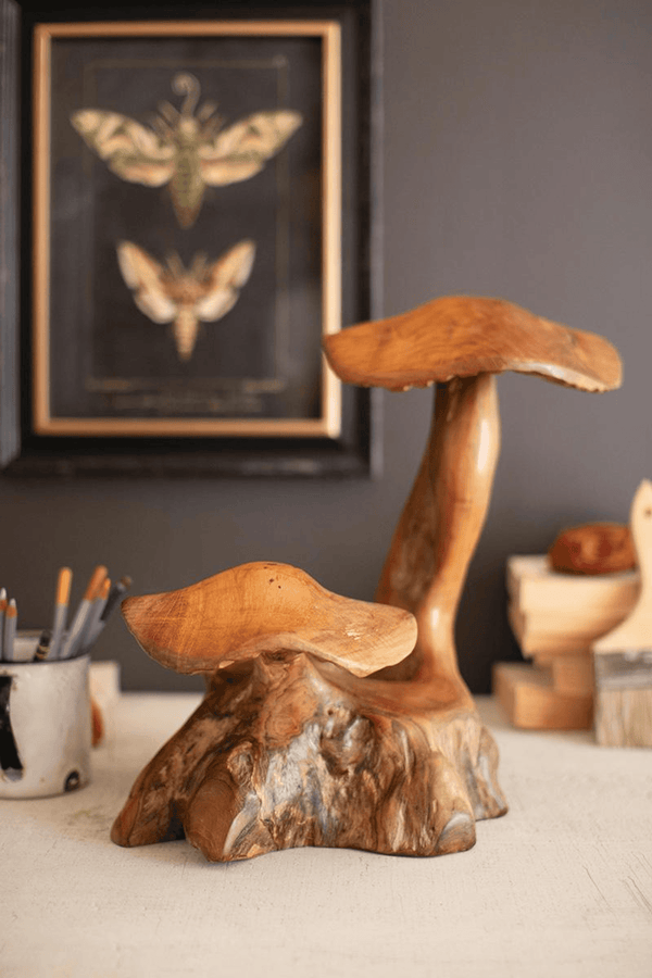 Double teak mushroom sculpture with two curved caps on a carved root base