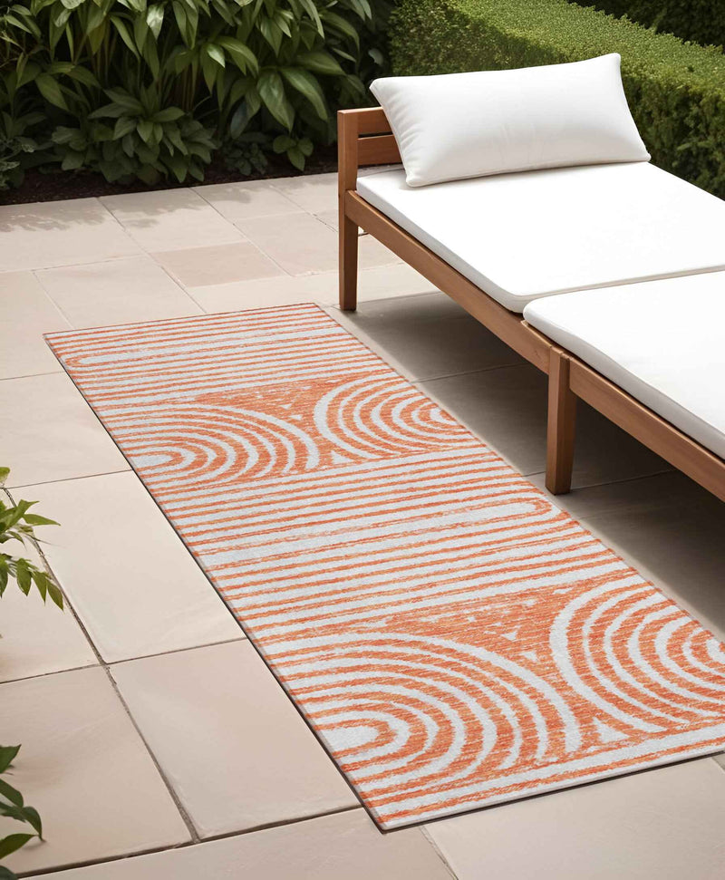 2' X 8' Orange and Ivory Abstract Washable Non Skid Indoor Outdoor Area Rug
