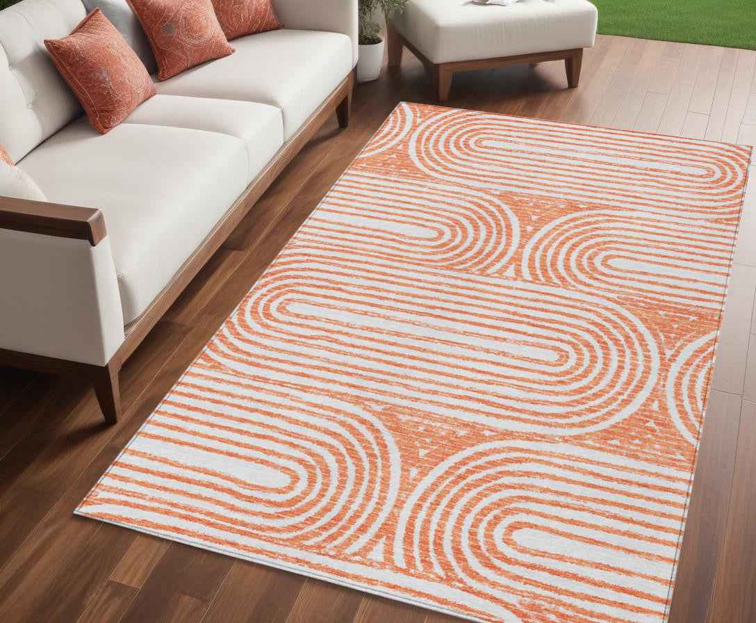 5' X 8' Orange and Ivory Abstract Washable Non Skid Indoor Outdoor Area Rug