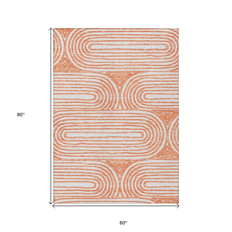 5' X 8' Orange and Ivory Abstract Washable Non Skid Indoor Outdoor Area Rug