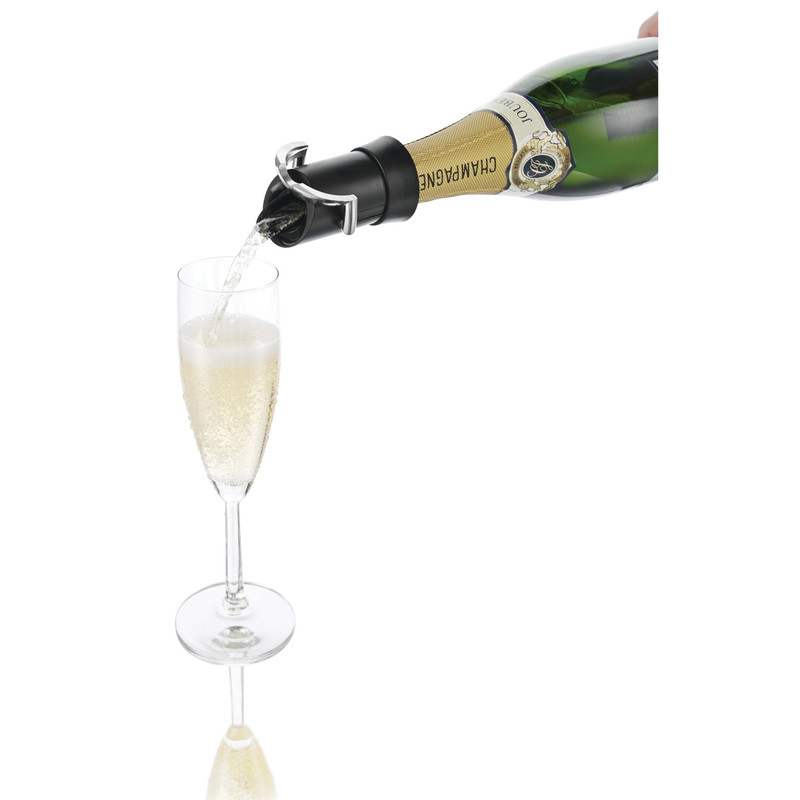 Black champagne saver stopper fitted on bottle, pouring into champagne flute