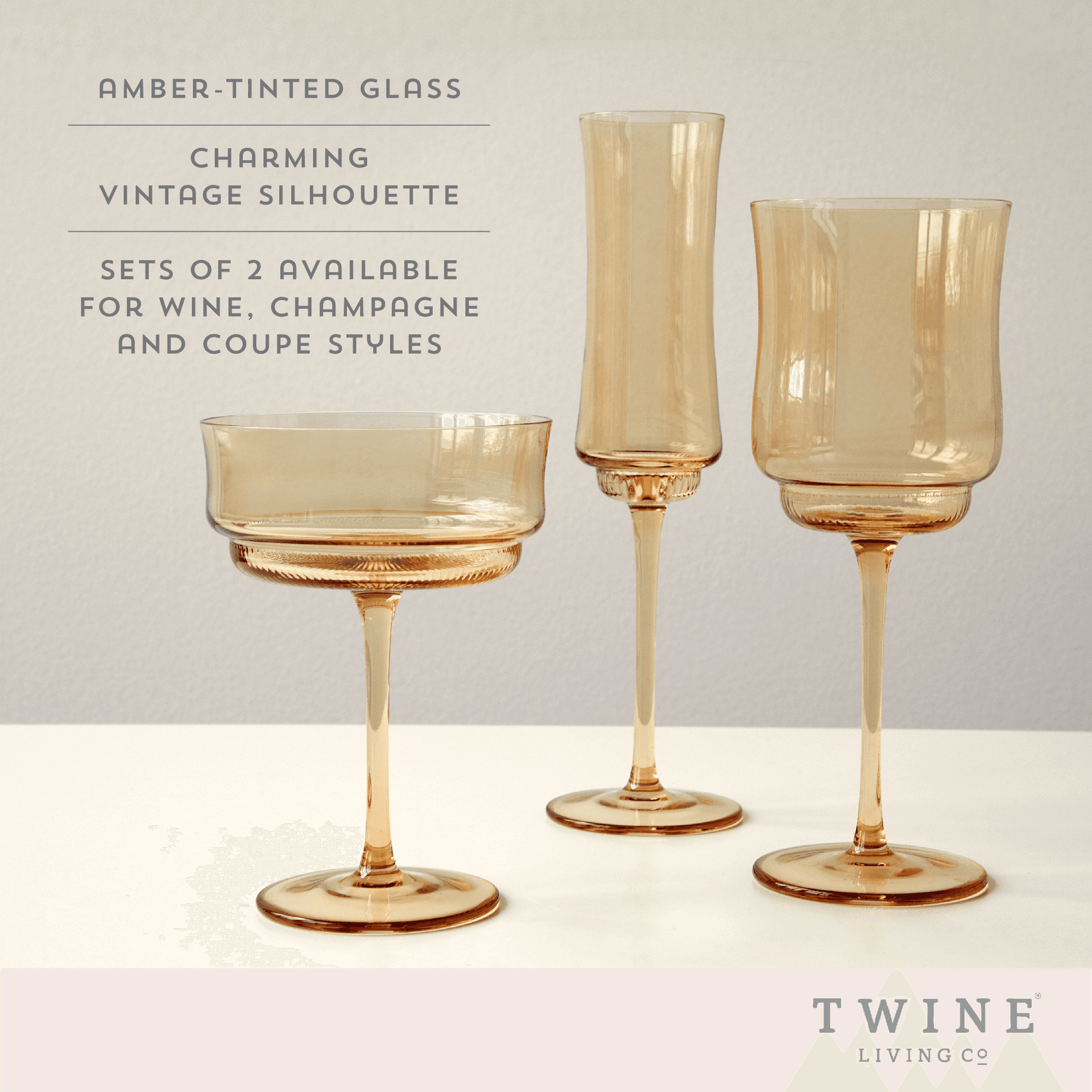 Amber-tinted tulip stem wine glasses with flared bowls and pedestal bases.