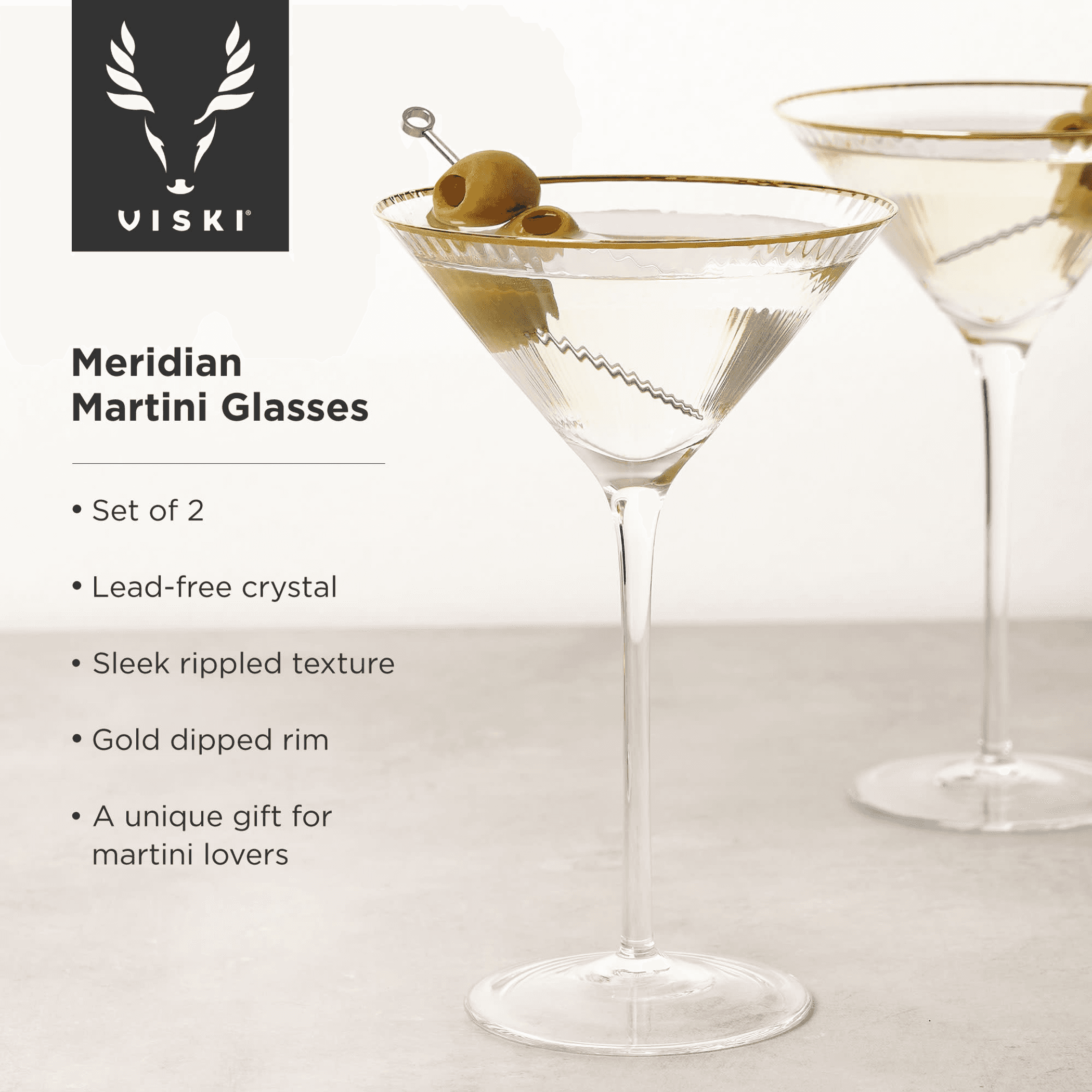 Clear rippled martini glass with gold-dipped rim and stem base, olives garnish