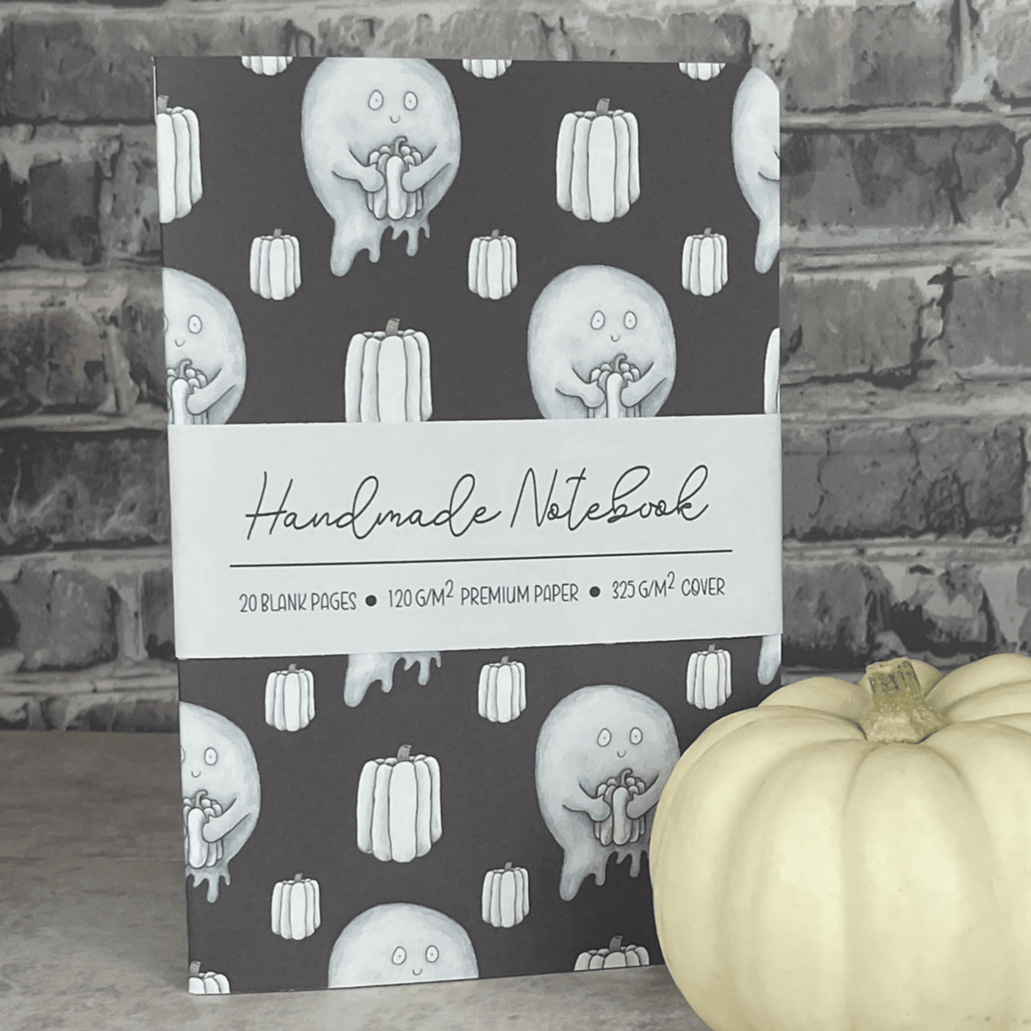Handmade notebook with repeating light blue ghost & pumpkin pattern on the cover