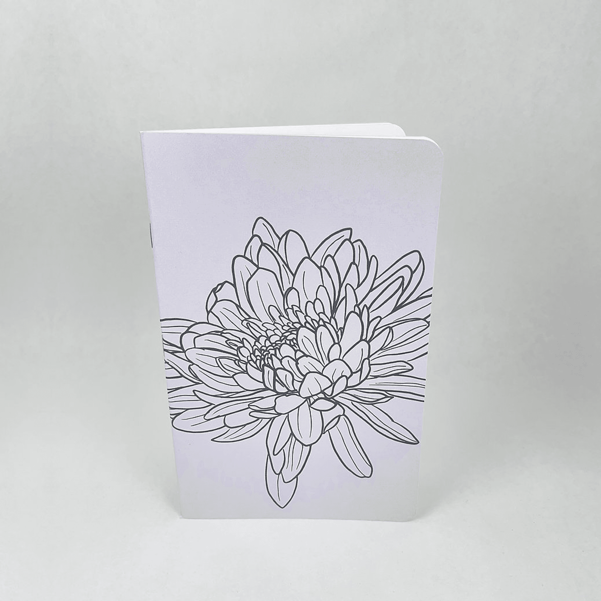 Lilac notebook with hand-drawn flower cover, shown standing upright