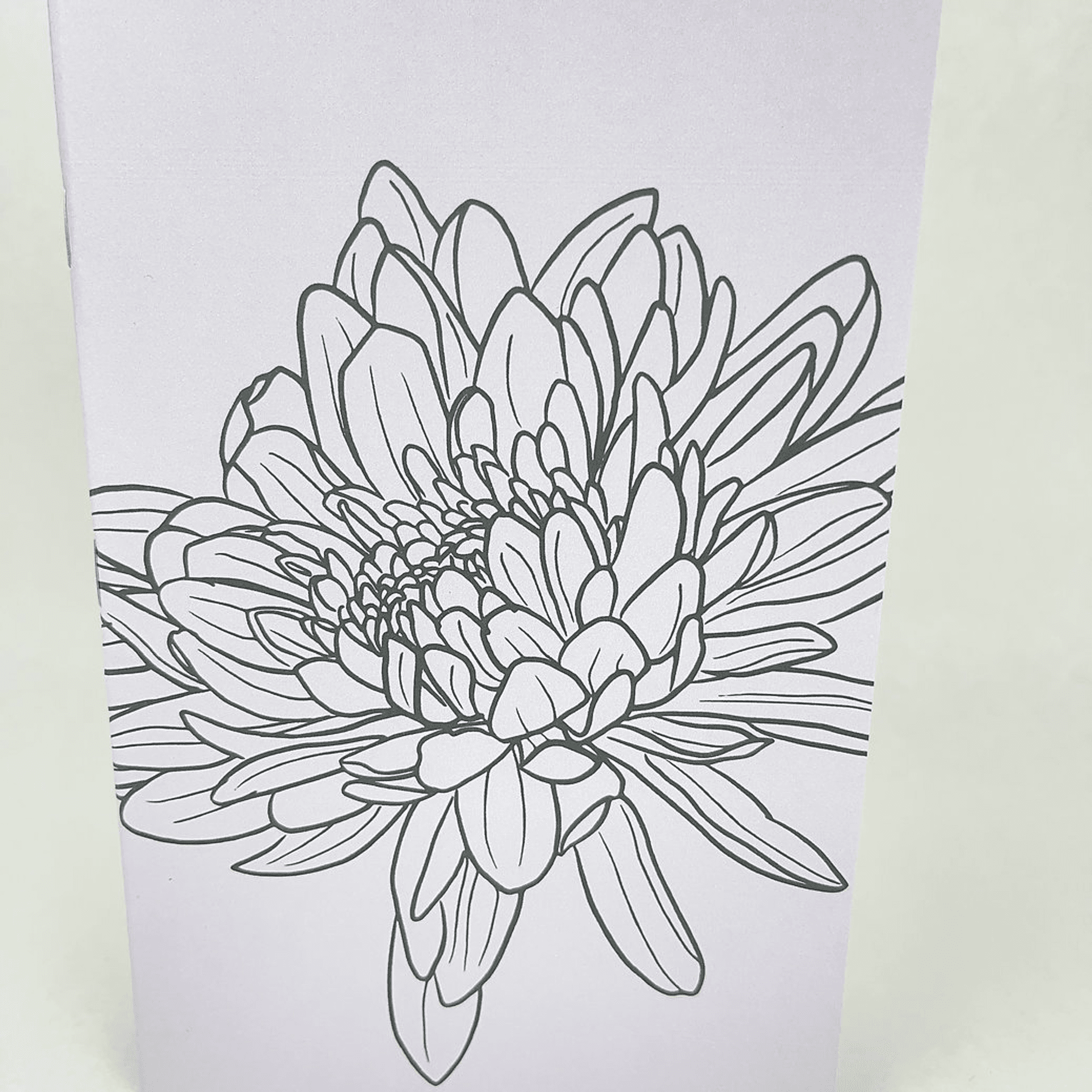 Close-up of lilac notebook cover with detailed hand-drawn flower line art