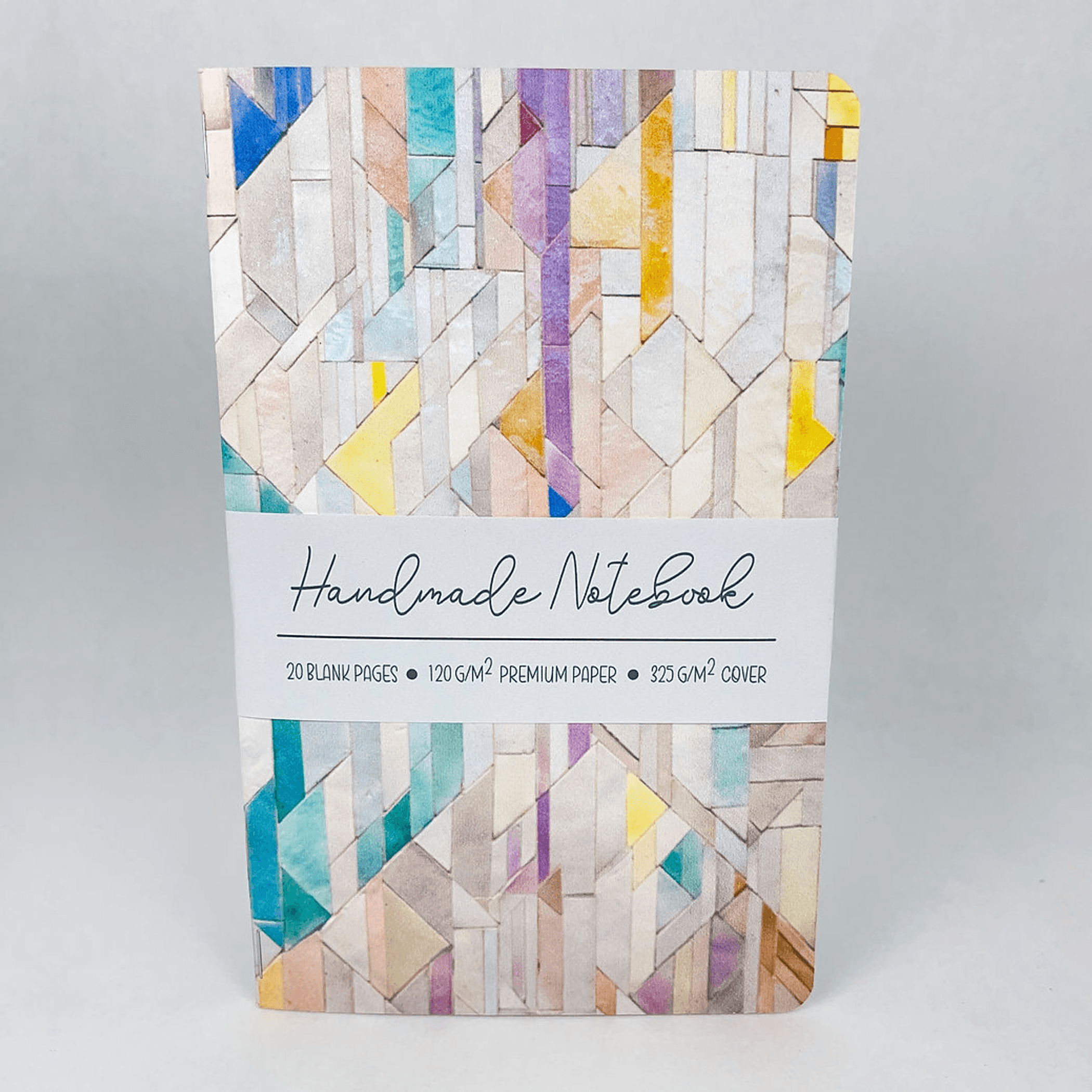 Handmade notebook with geometric tile cover and label strip centered on the front.
