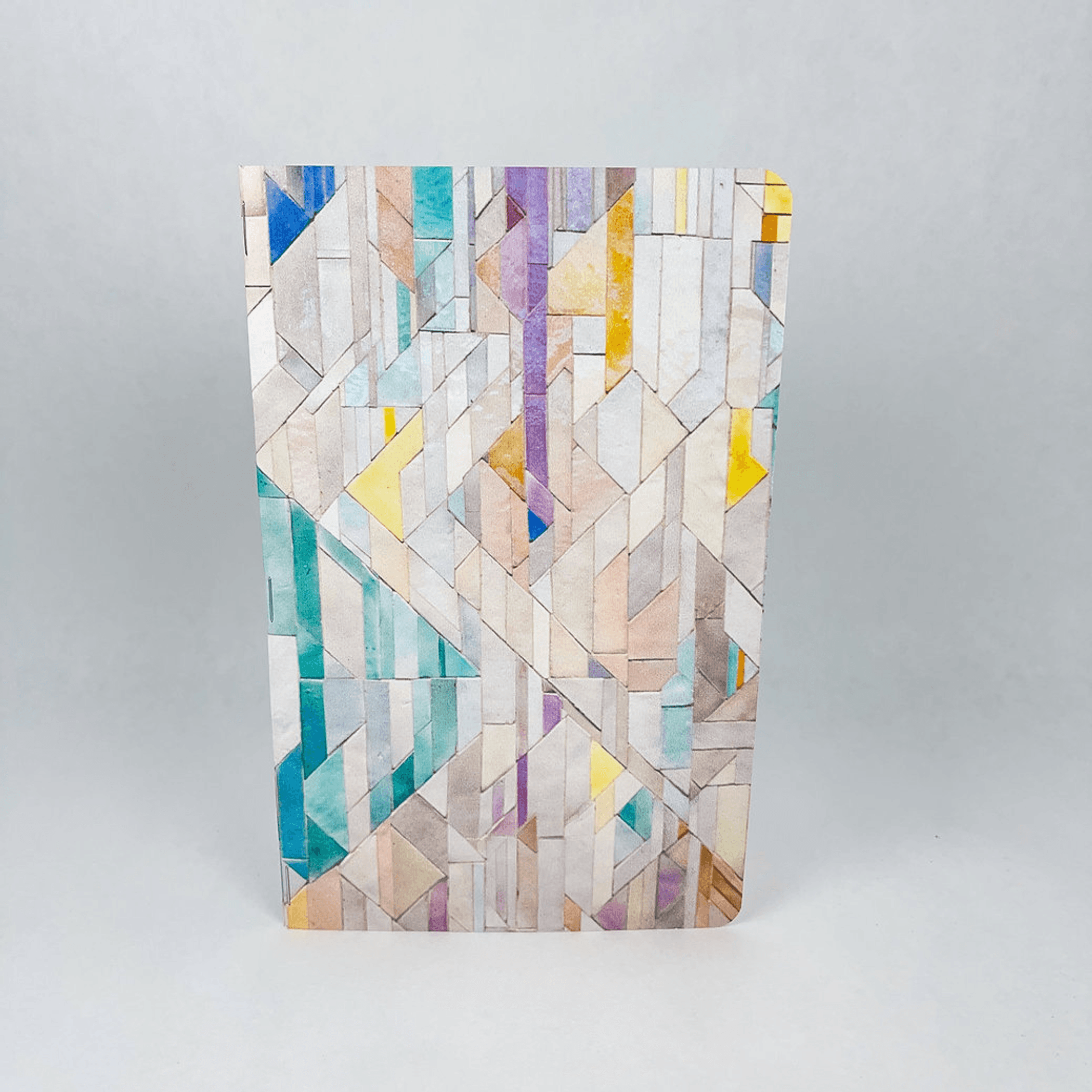 Handmade notebook back cover with multicolor geometric tile pattern.