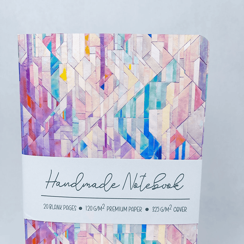 Handmade notebook with geometric tile cover and “Handmade Notebook” title on the label