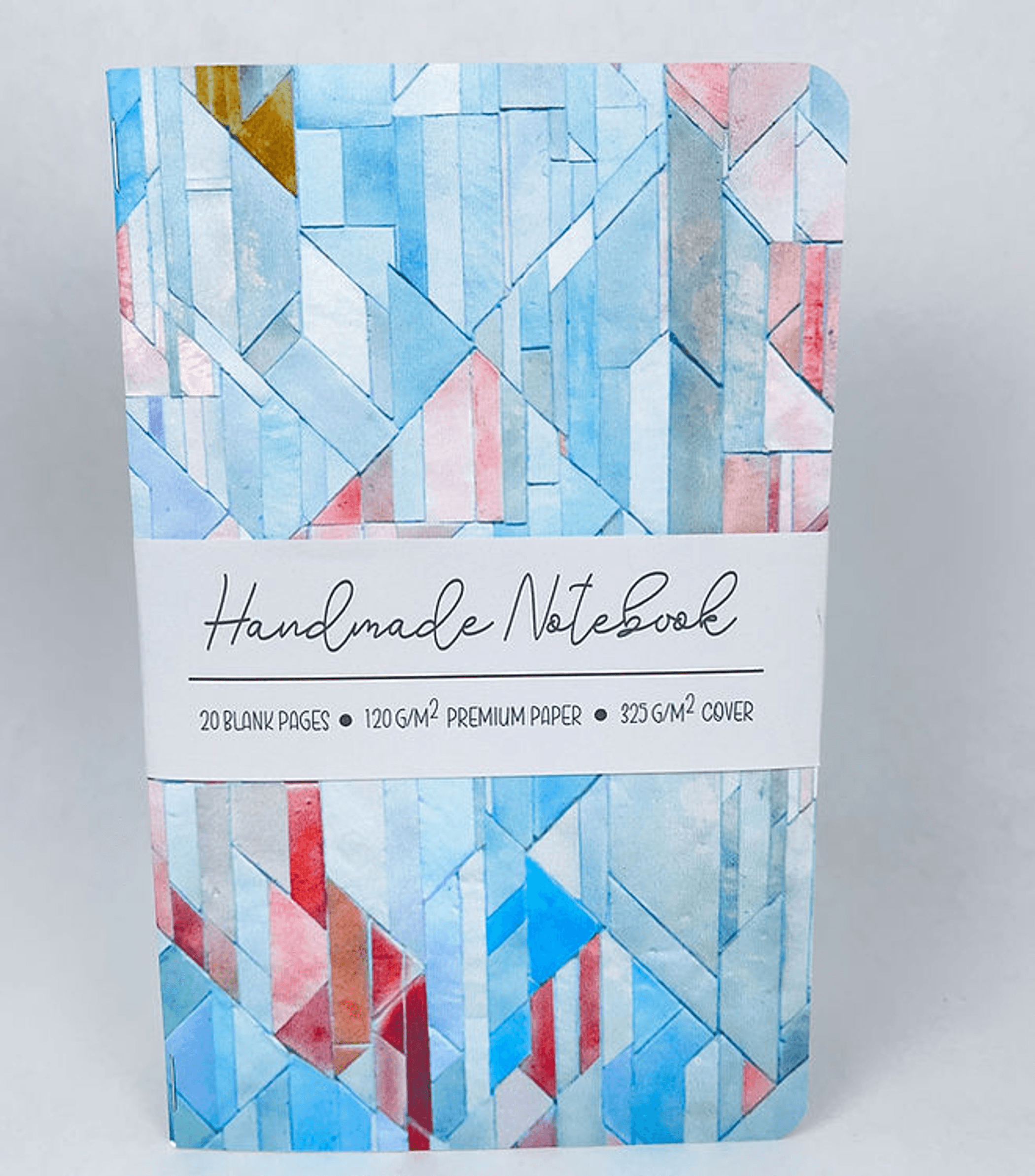 Geometric tiles notebook front with blue and red pattern and white label