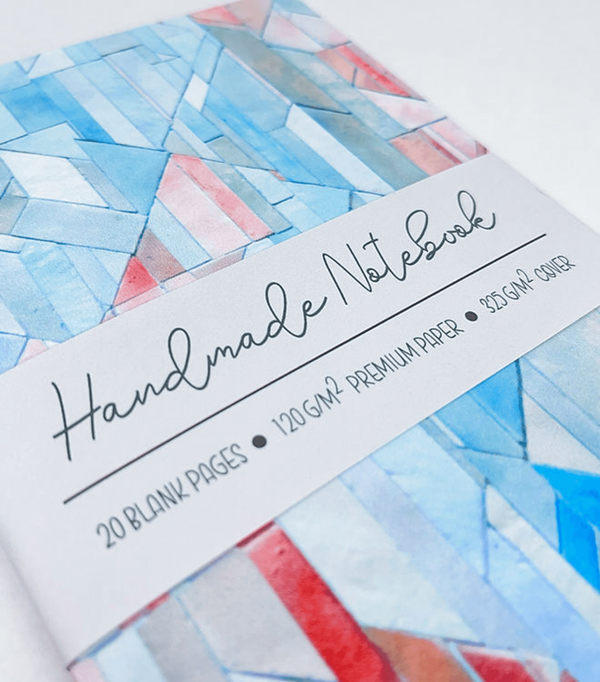 Handmade notebook with blue geometric cover and white band label