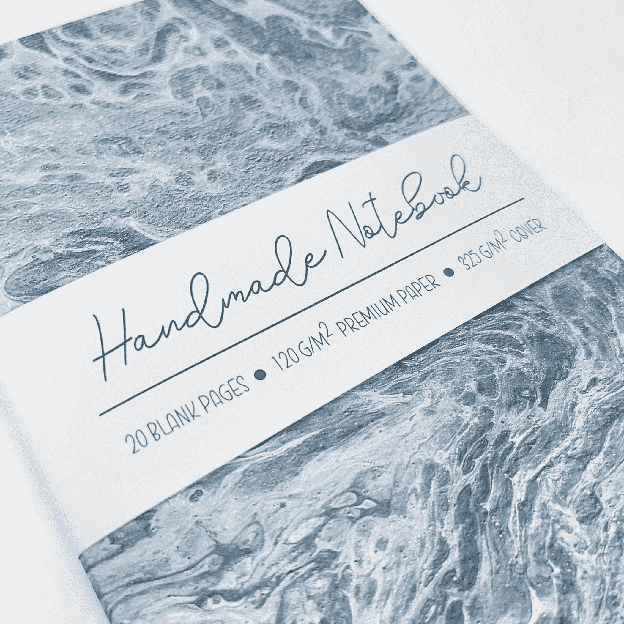Blue marbled notebook cover with handmade label and 20 blank pages text