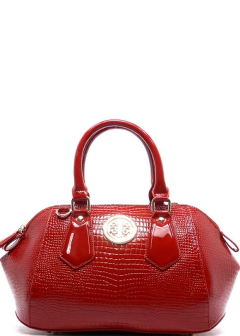 Burgundy textured handbag with two top handles, front logo medallion, and zip top