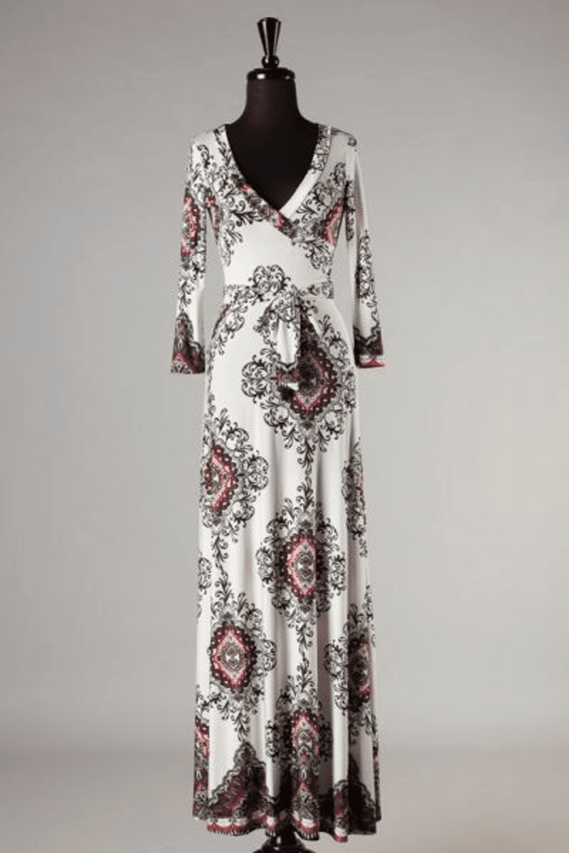 Ivory maxi dress with V-neck, long sleeves, and flowing full-length paisley pattern skirt.