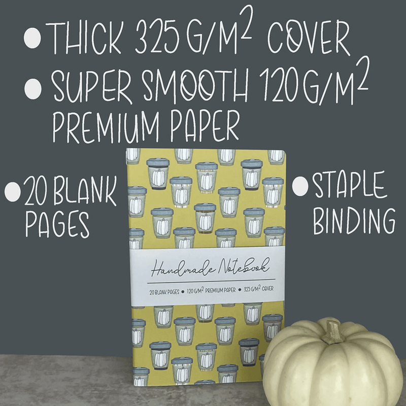 Mustard notebook cover with pumpkin spice mug pattern and stapled binding