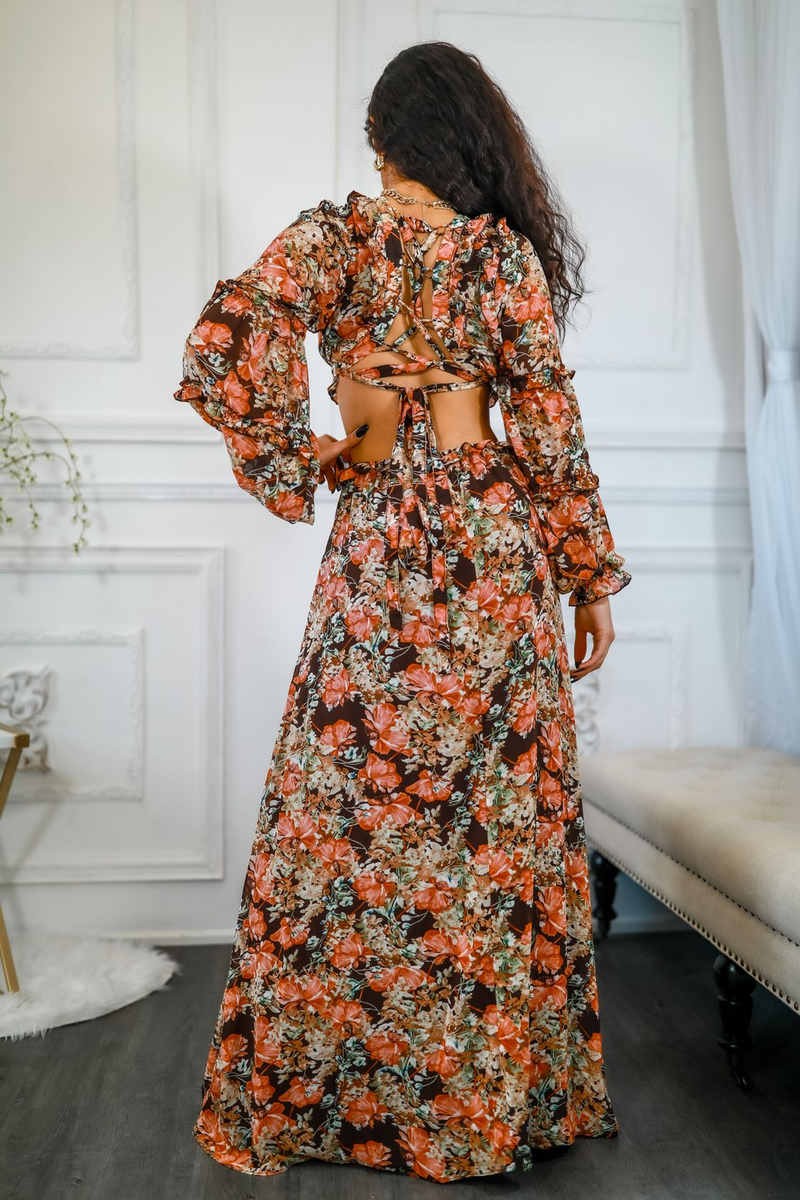 Floral maxi dress shown from the back with open back straps and waist cut-out; orange print.