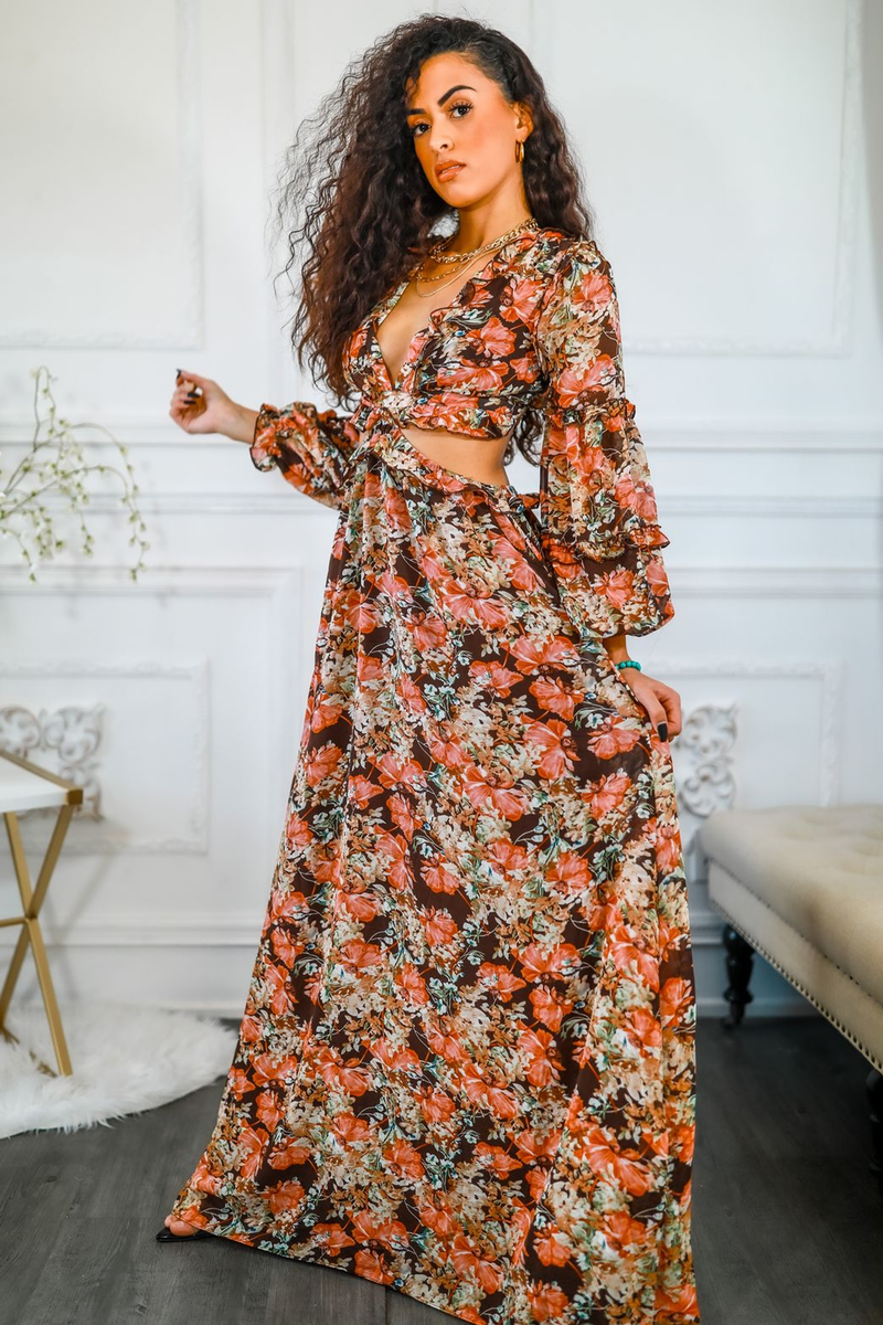Floral maxi dress with V-neck and waist cut-out; long puff sleeves; orange floral print.