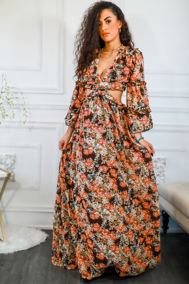 Floral maxi dress with V-neck, long sleeves, and waist cut-out; orange, green, and white print.
