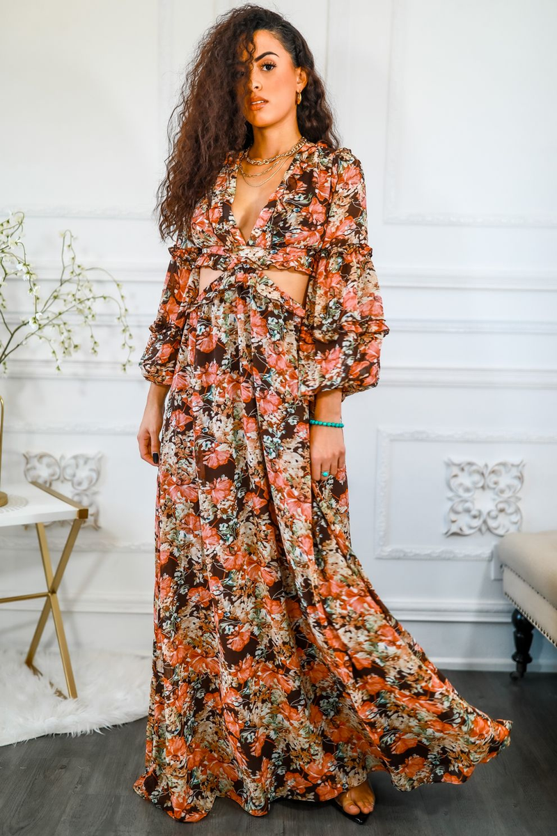 Floral maxi dress with V-neck and waist cut-out; flowing skirt; orange floral print.