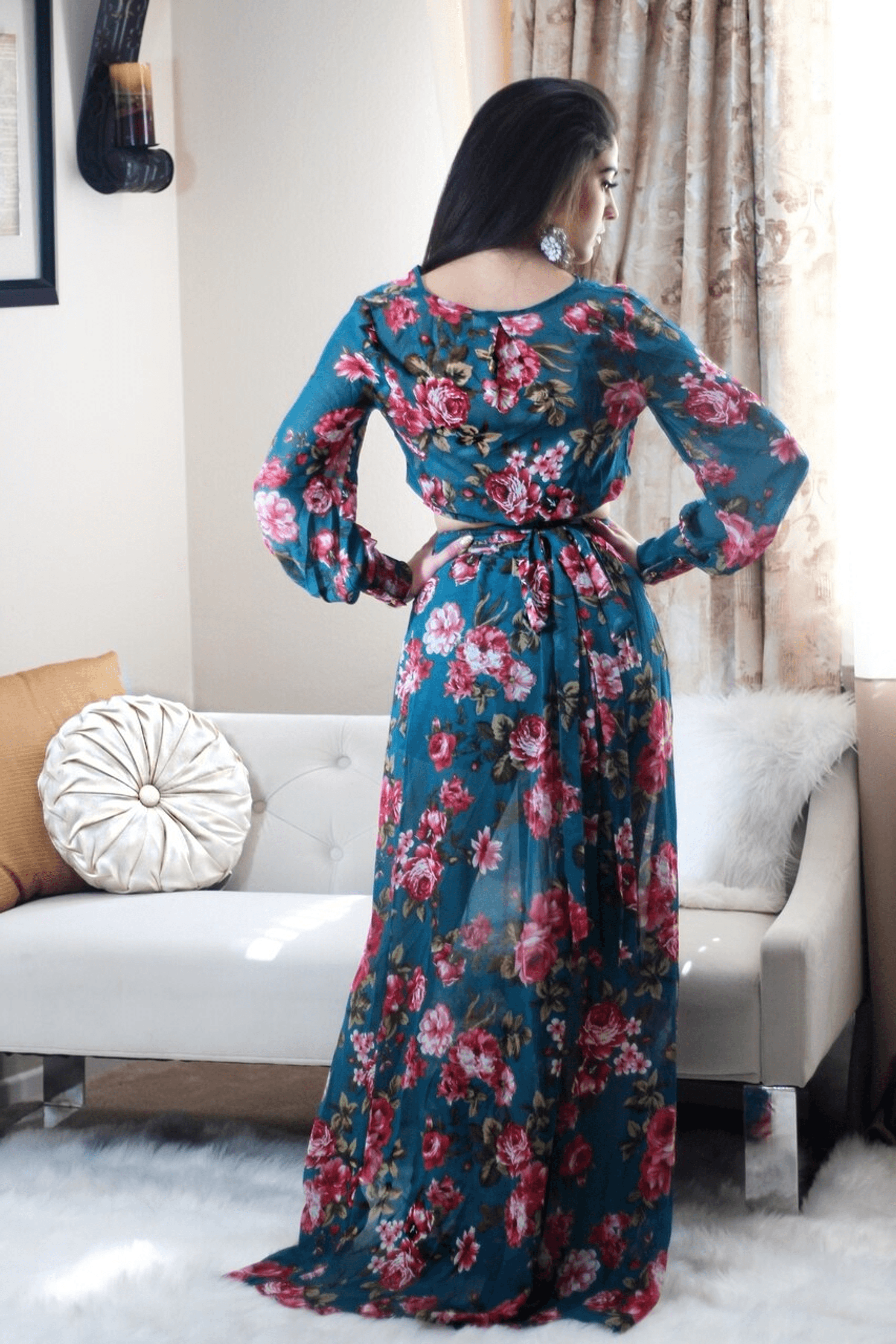 Back view of floral maxi set with long sleeves, tie waist, and flowing skirt with side slit