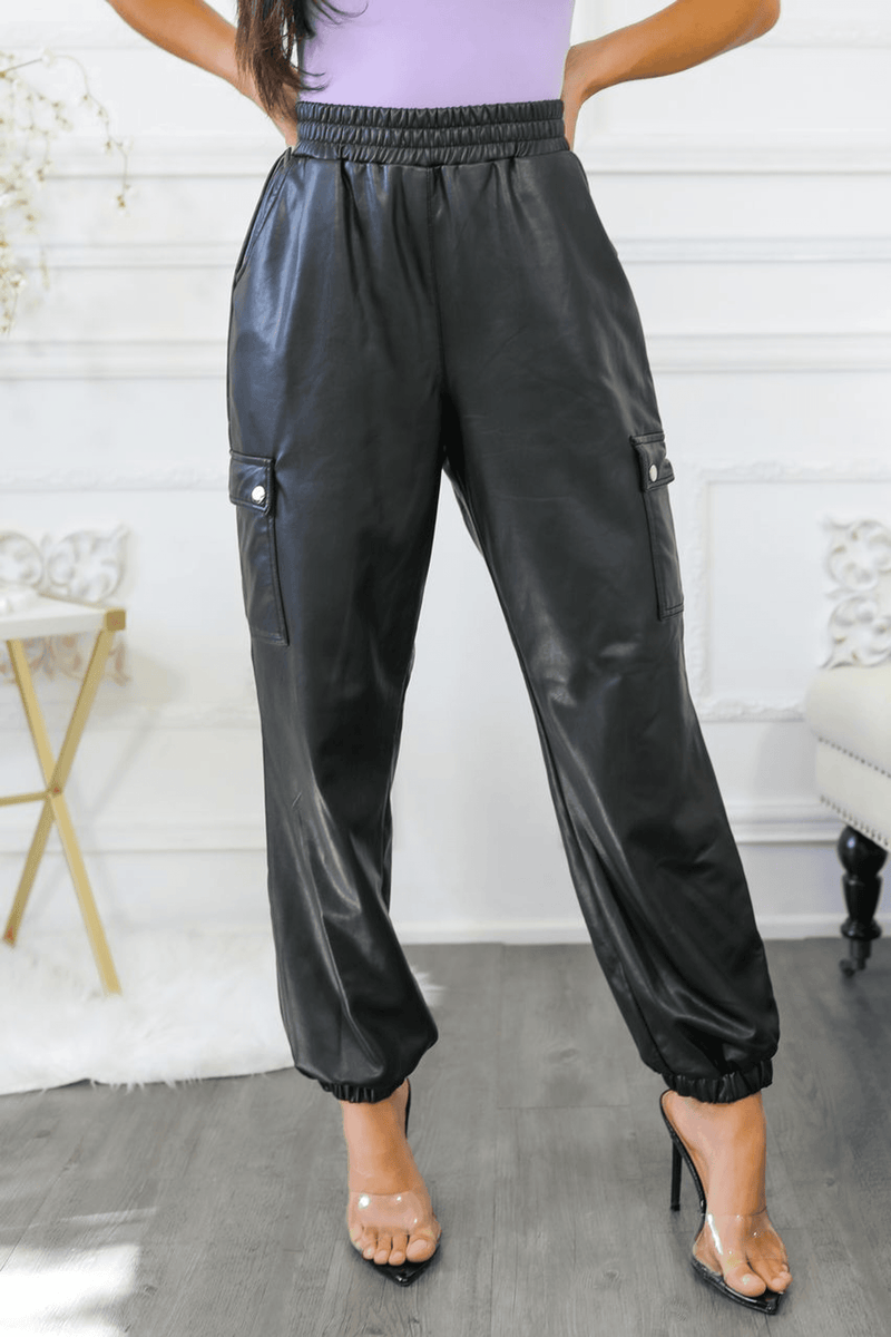 Dark faux leather cargo jogger pants with cargo flap pockets at hips