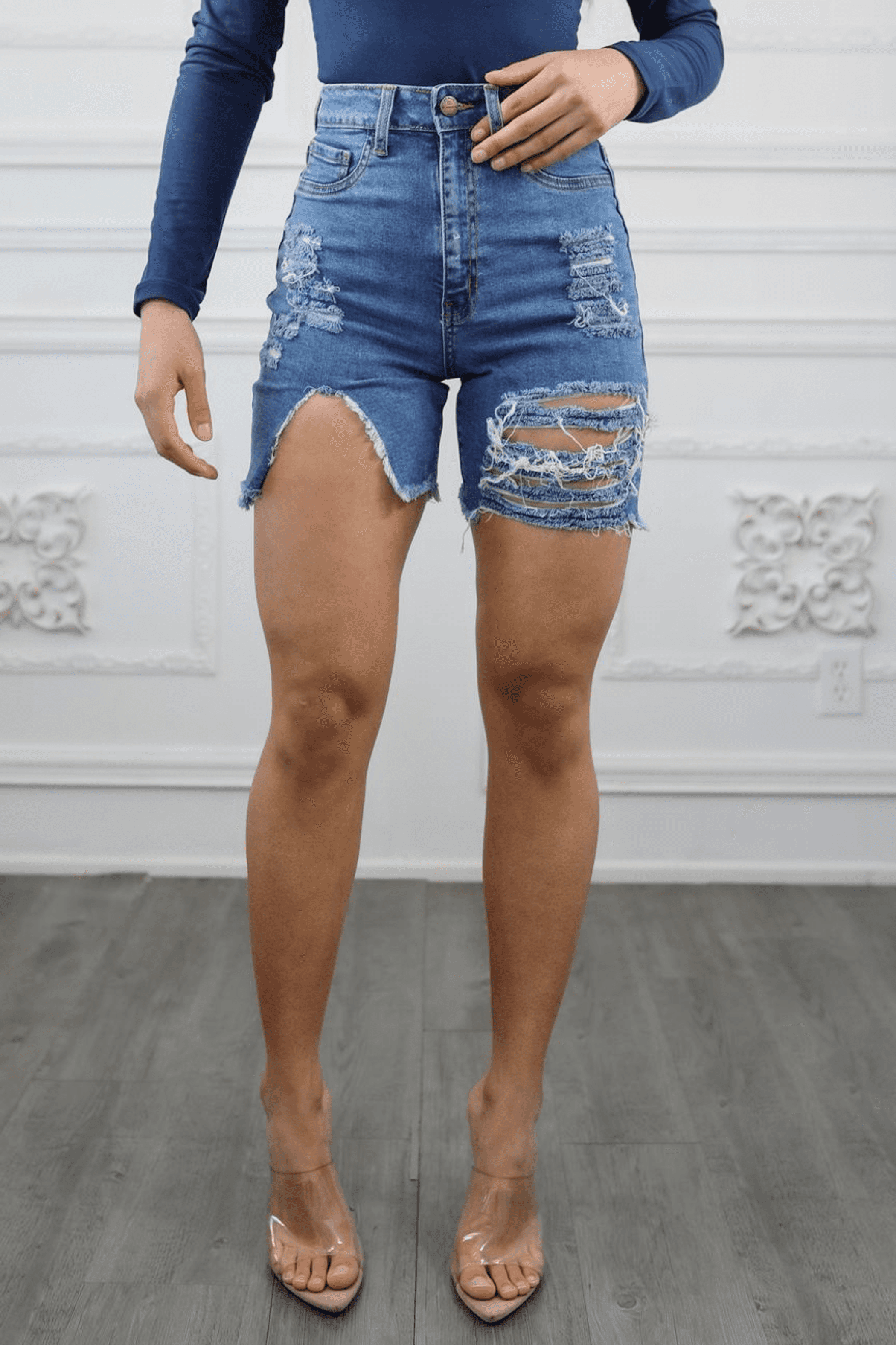 Women’s cut-out high waist distressed denim shorts with frayed hem and worn-in detailing