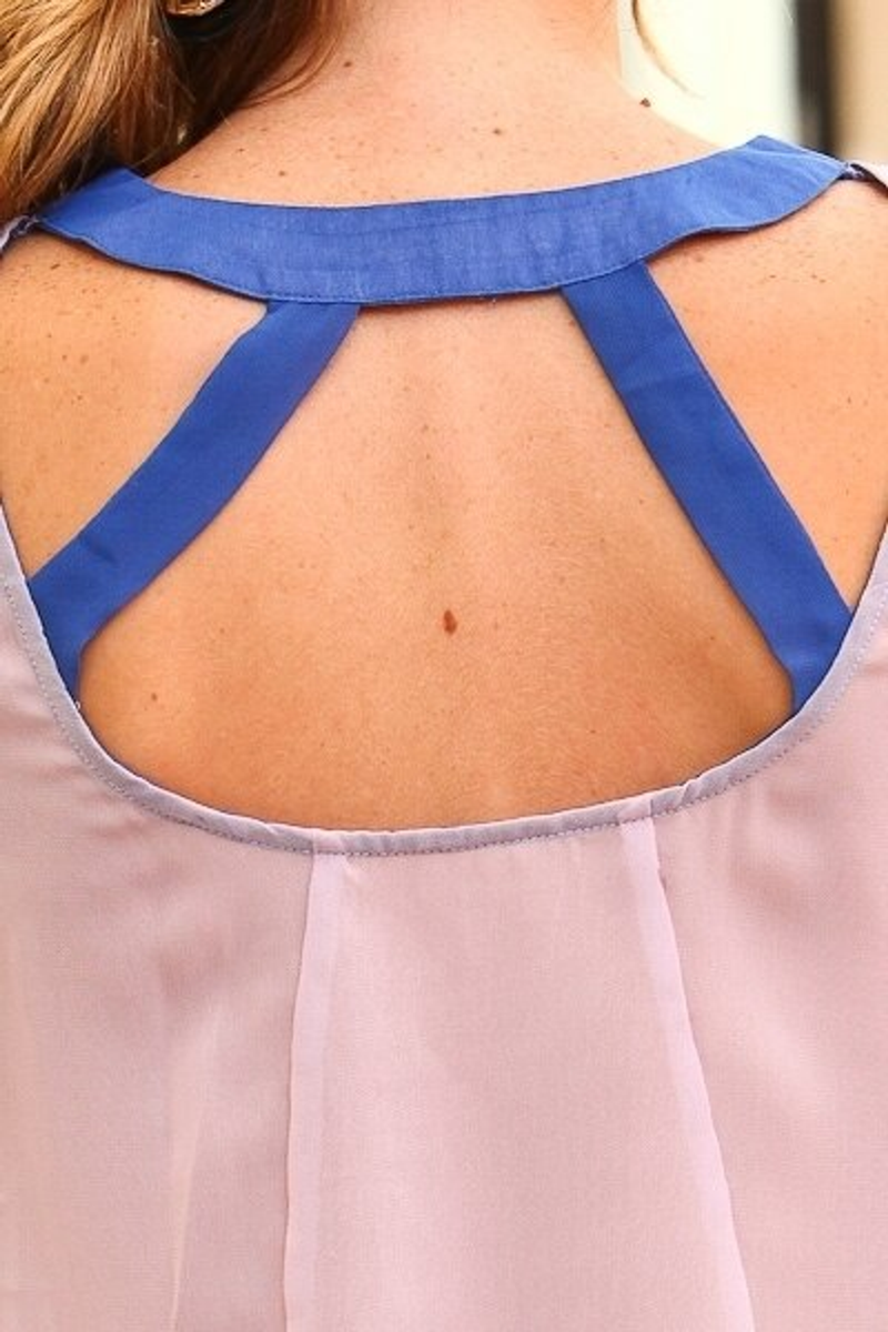 Sheer sleeveless blouse neckline with blue ruffle and open back straps