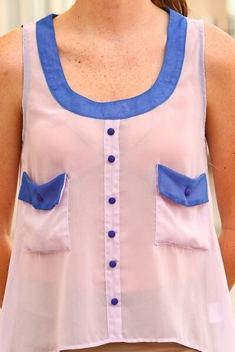 Sheer sleeveless blouse front with blue trim, button placket, and chest pockets
