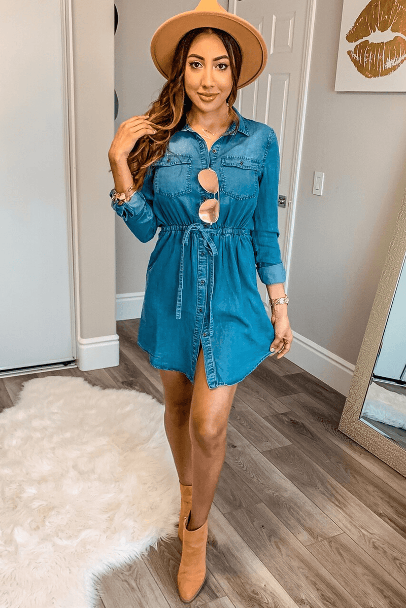Blue denim midi shirt dress with button front, chest pockets, gathered waist cutouts