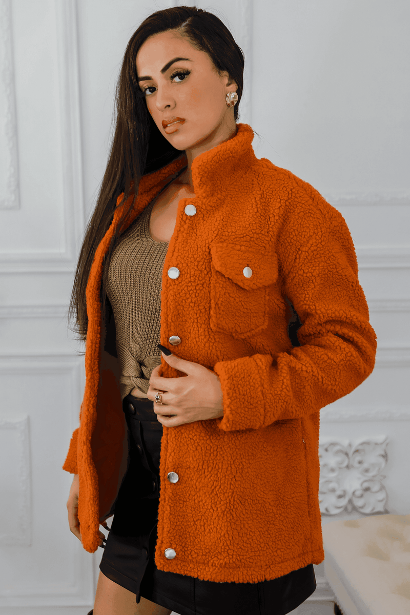 Orange sherpa jacket with button-up front and flap pockets, side view