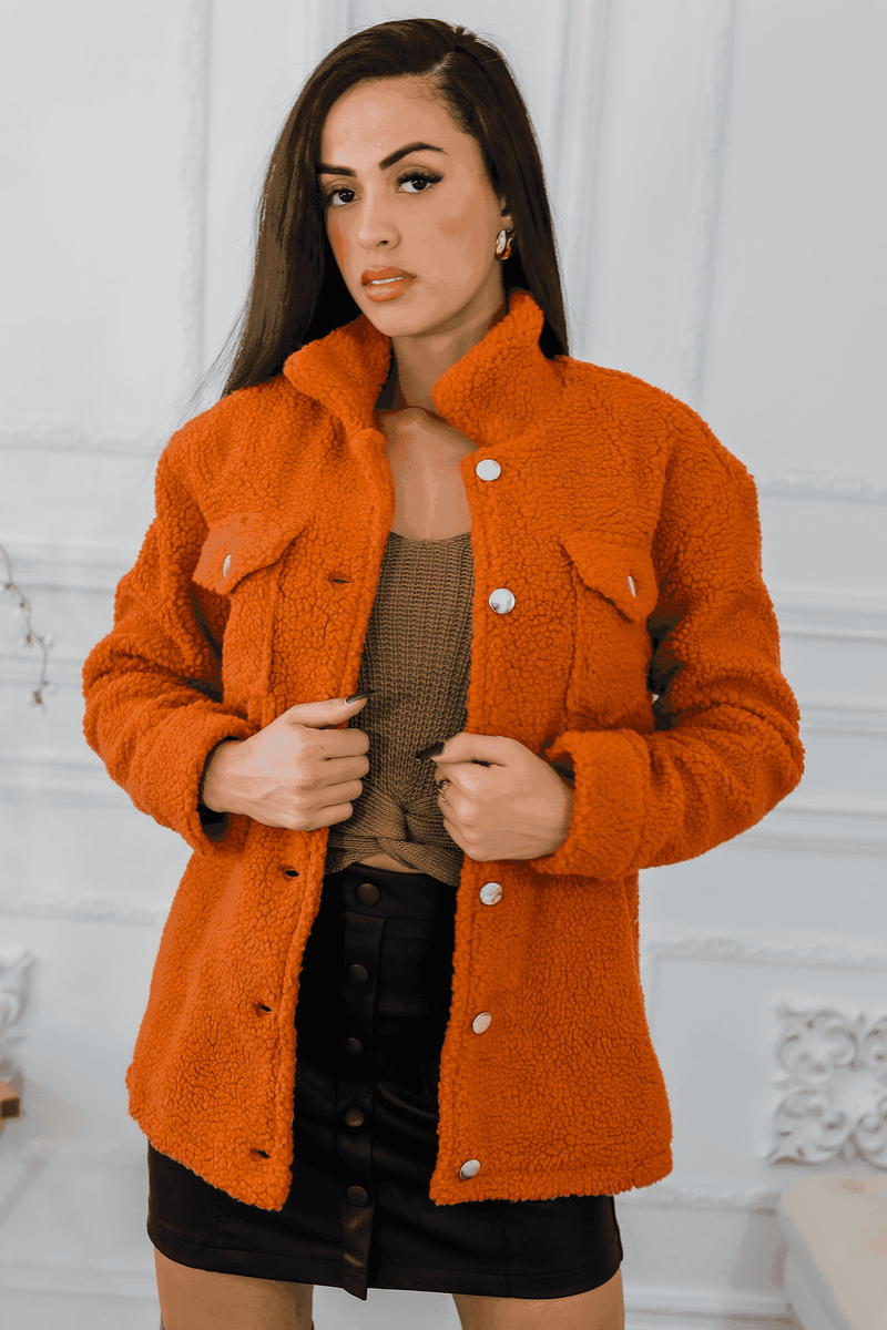 Orange sherpa jacket with button front, notch collar, and flap pockets