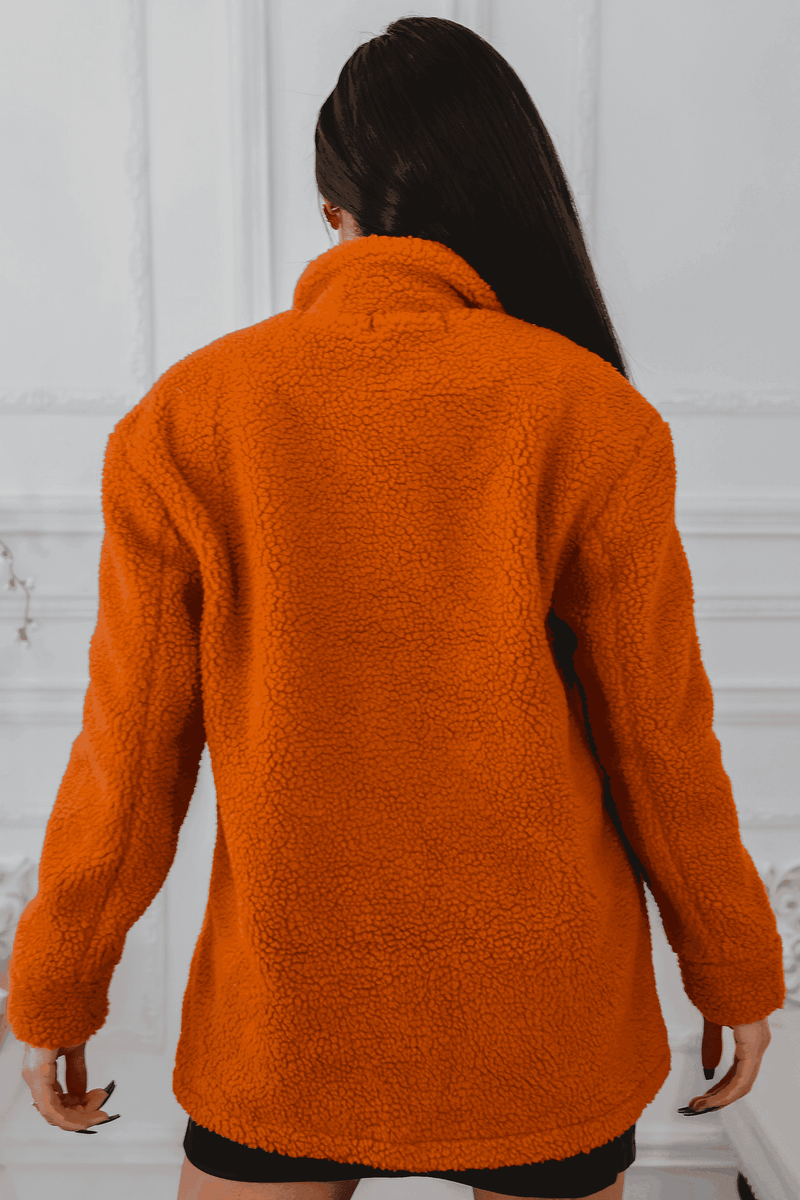 Cozy orange fleece jacket with a high collar and relaxed fit, perfect for casual layering in colder weather.