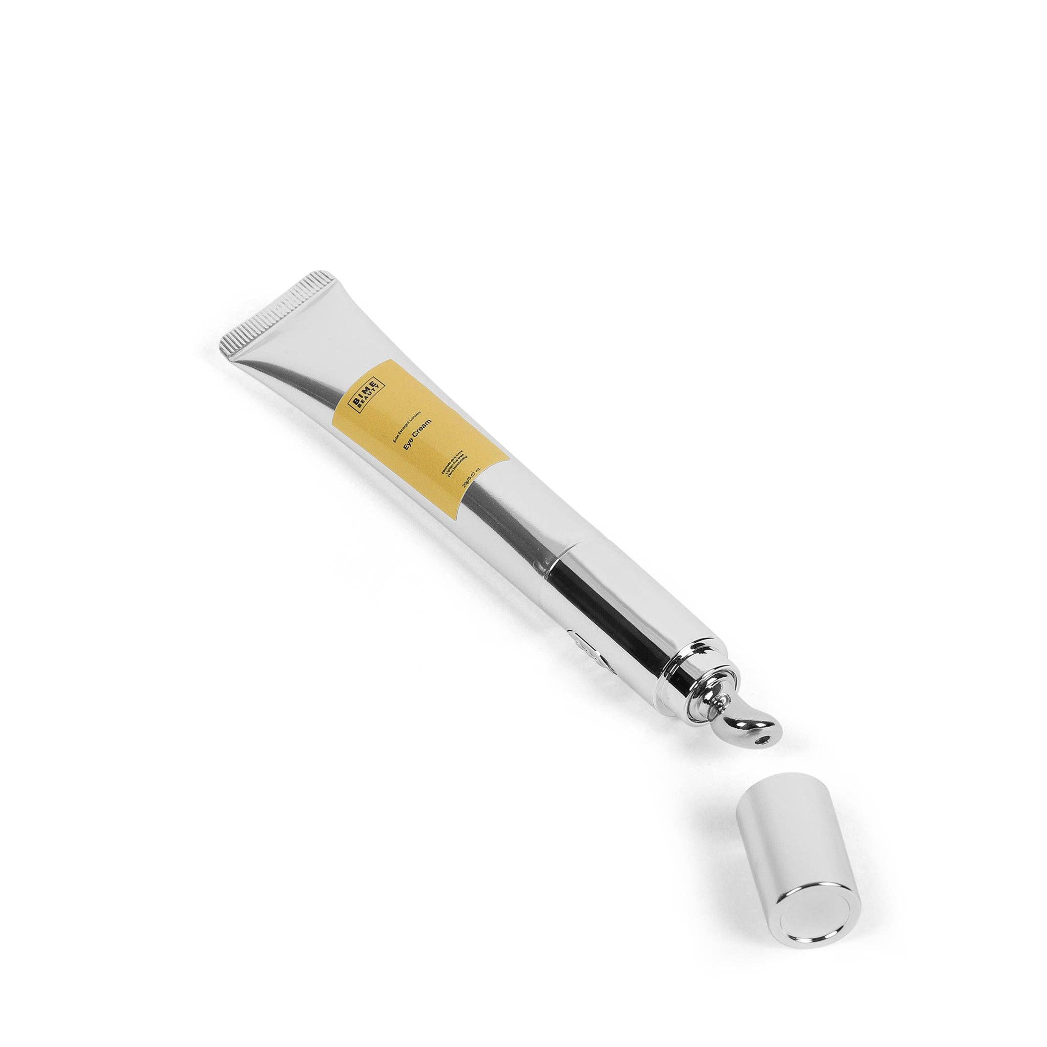 White eye cream tube with silver roller applicator