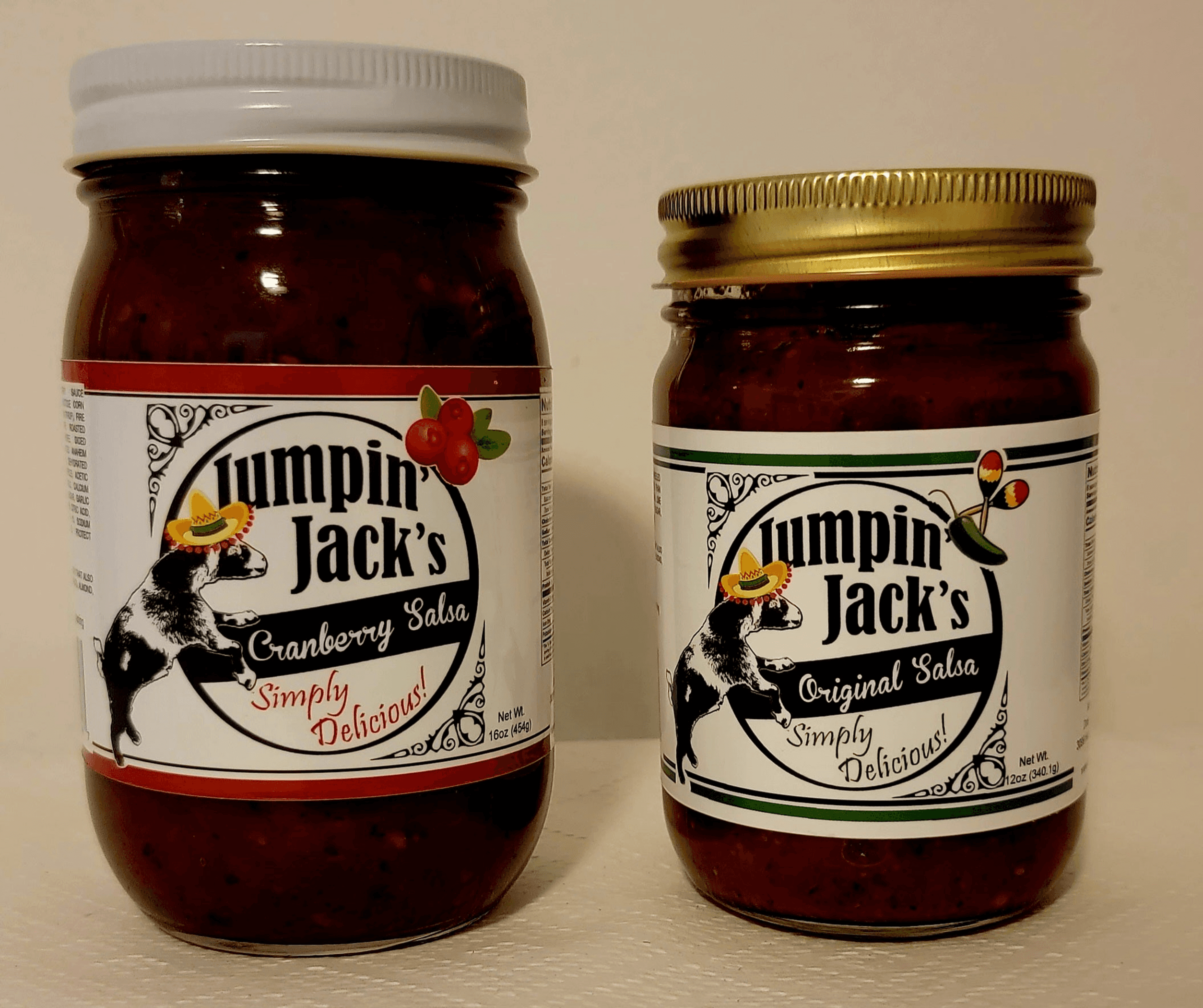 Two Jumpin' Jack's salsa jars, one larger one smaller, gold and light lids