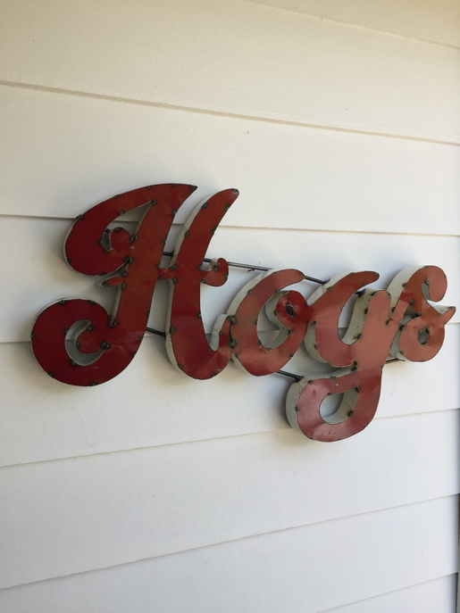 Recycled metal wall decor with red “Hogs” cutout letters and metal accents
