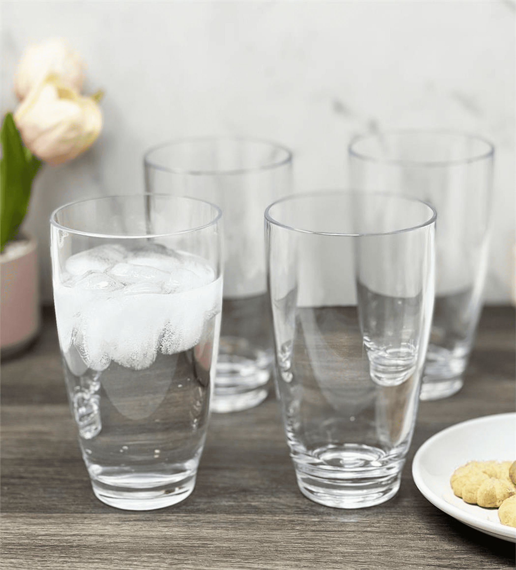 Set of clear acrylic highball tumblers with ice, 19 oz capacity