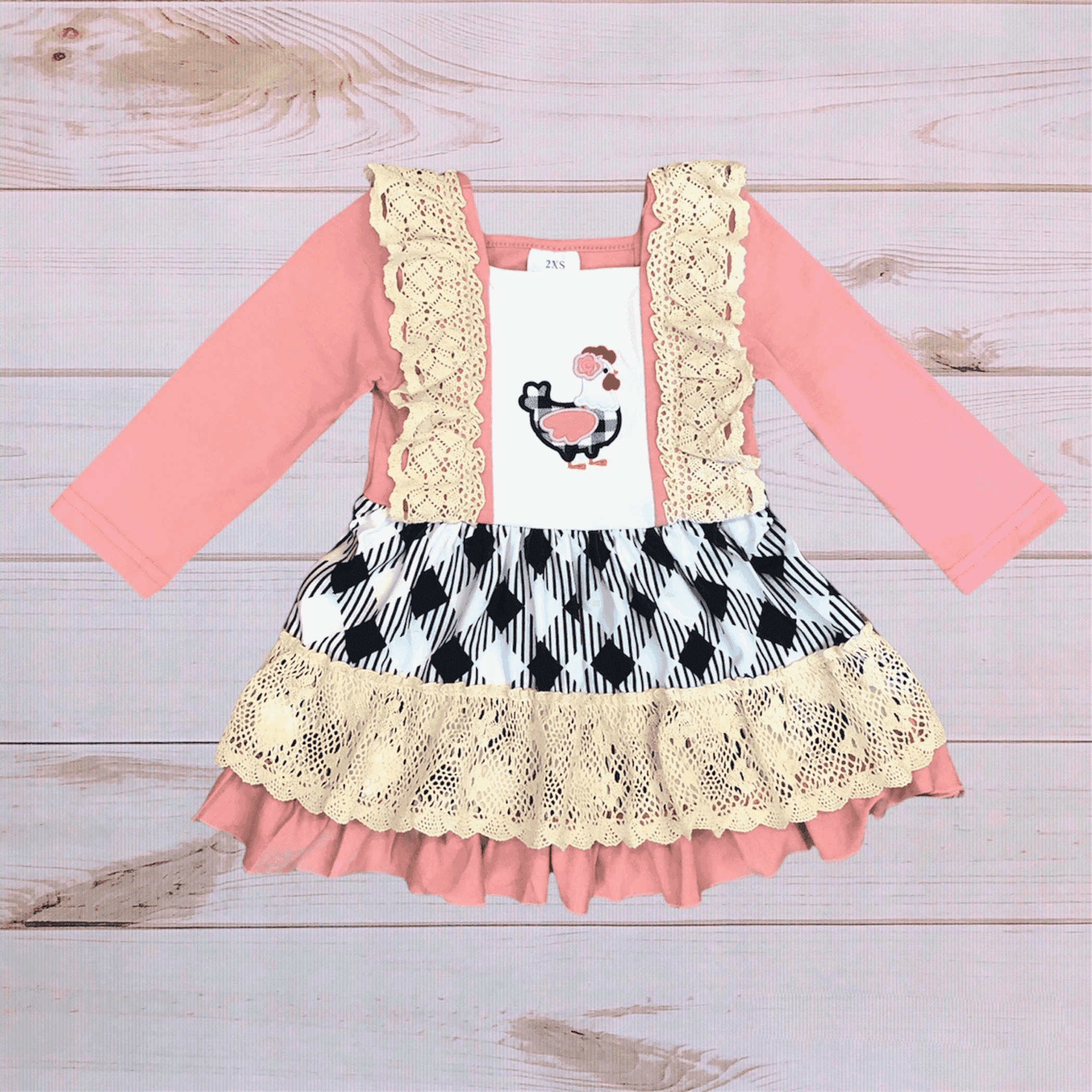 Chicken plaid dress with pink sleeves, lace trim, black-and-white skirt, ruffled hem