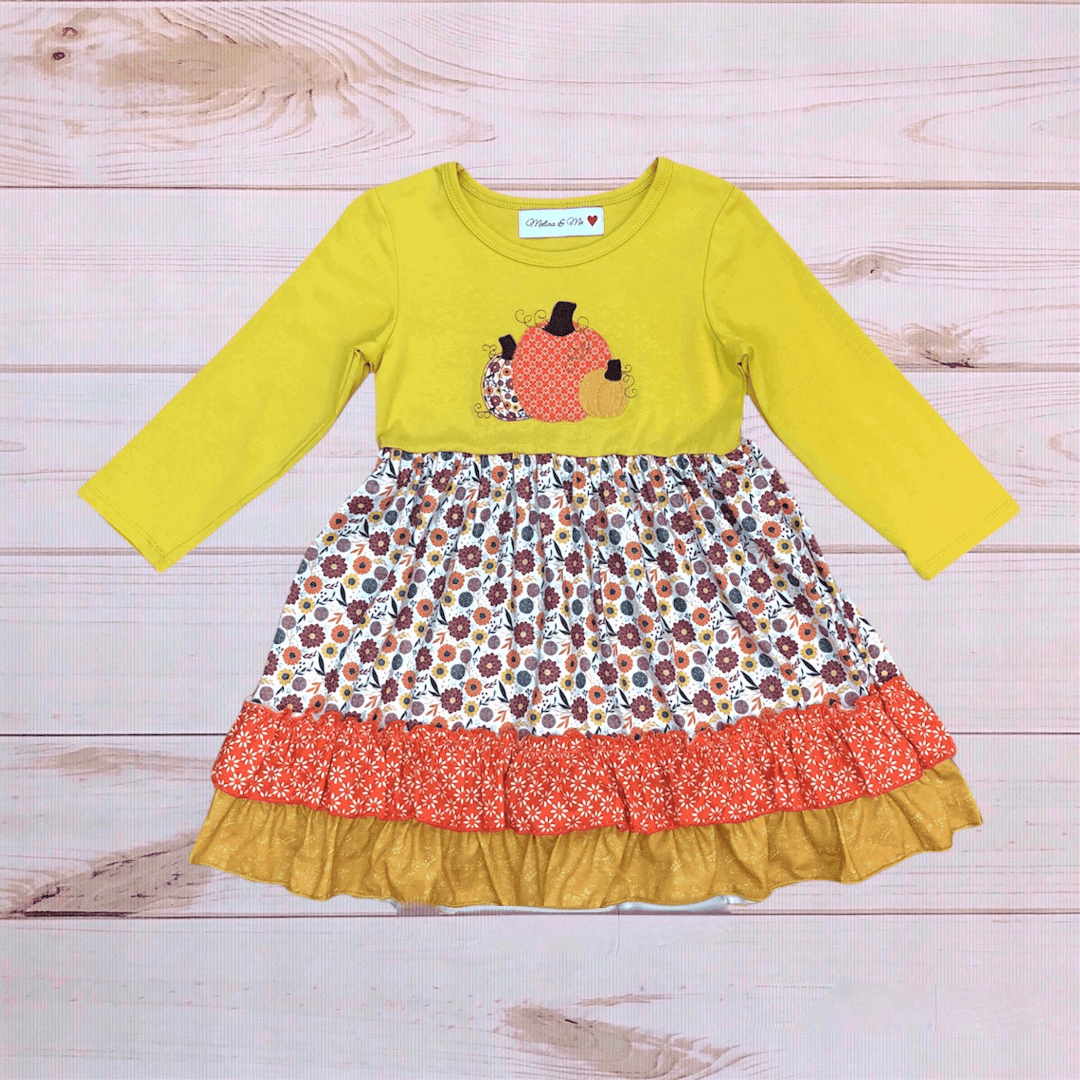 Pumpkin Patch floral dress with yellow long sleeves and layered red/white floral skirt, gold hem