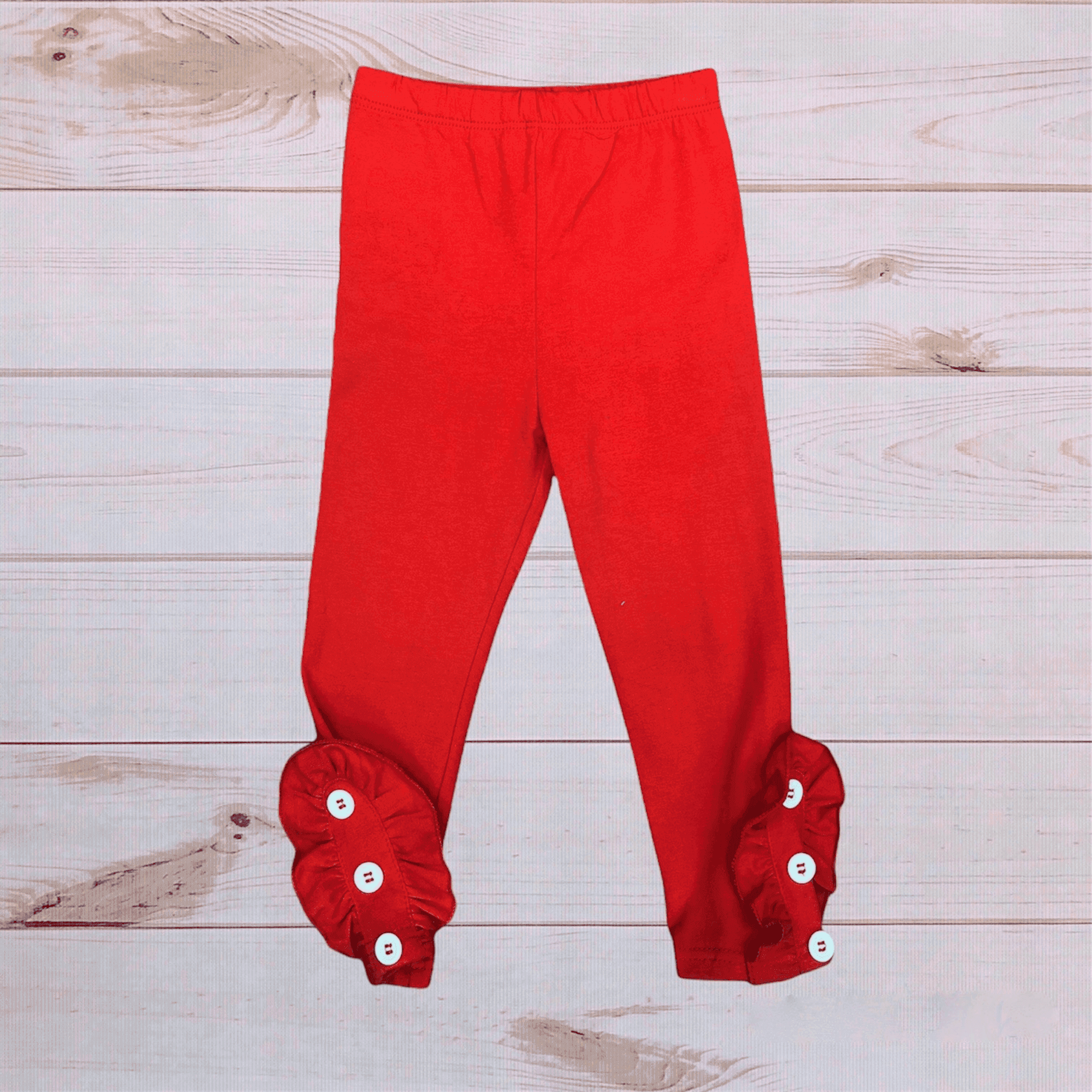 Red pants with elastic waistband and buttoned fabric cuffs at ankles